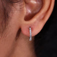 Close-up of baguette diamond hoop earrings