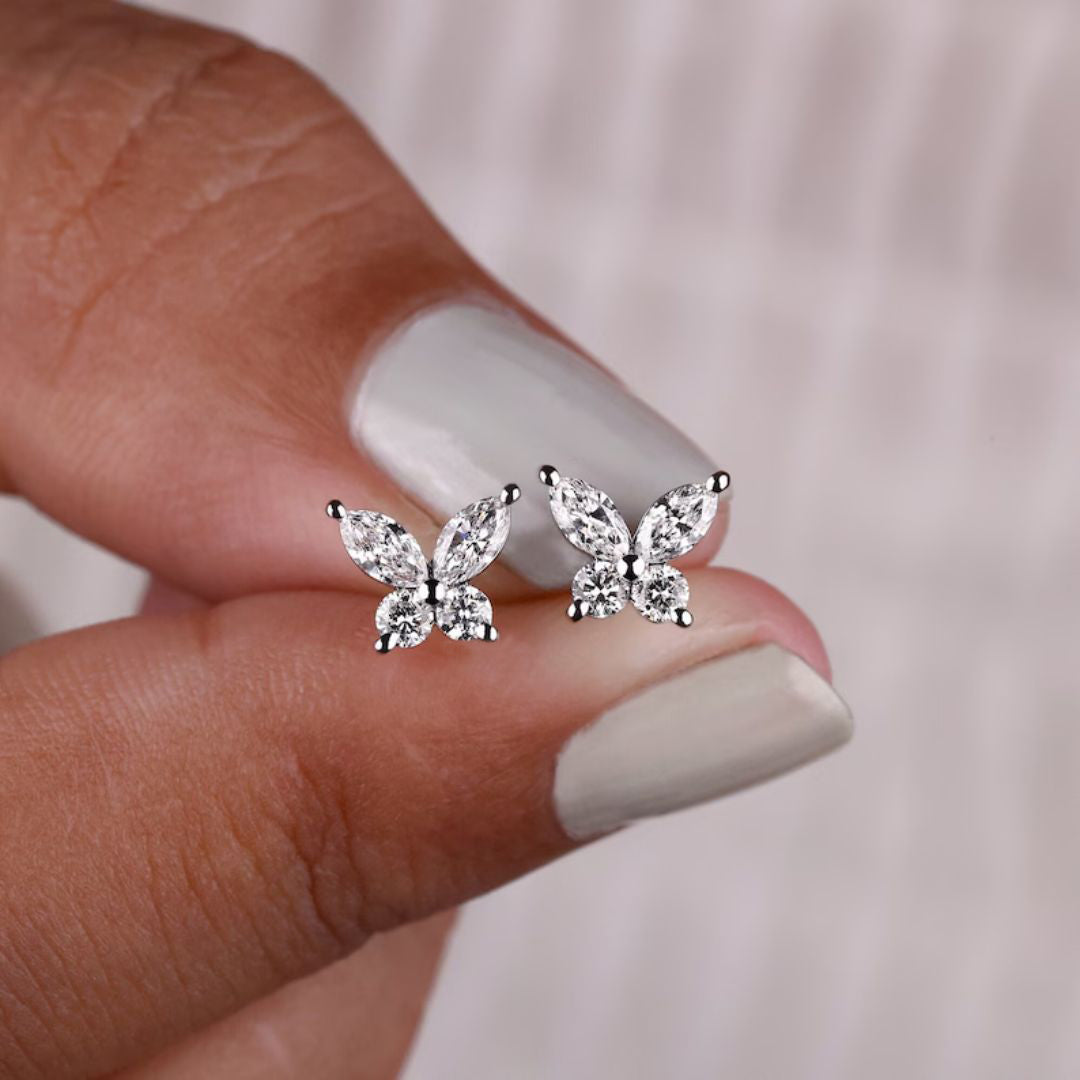 Marquise cut Moissanite butterfly stud earrings in white gold for a unique design.
