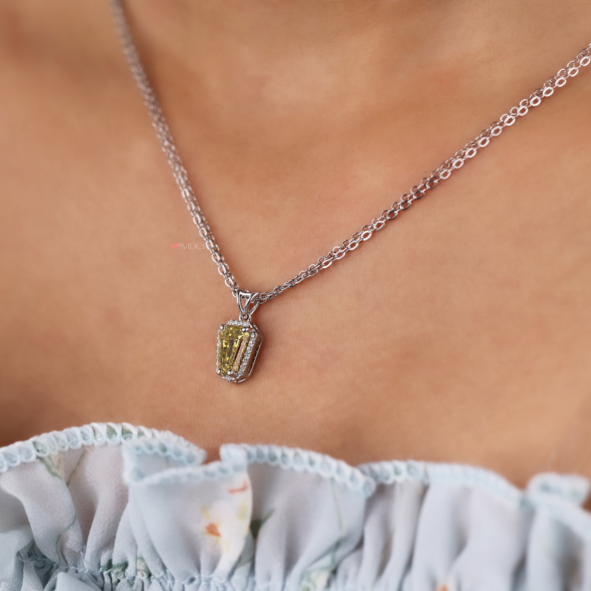 Shield cut halo pendant pairs modern design with sparkling accents.