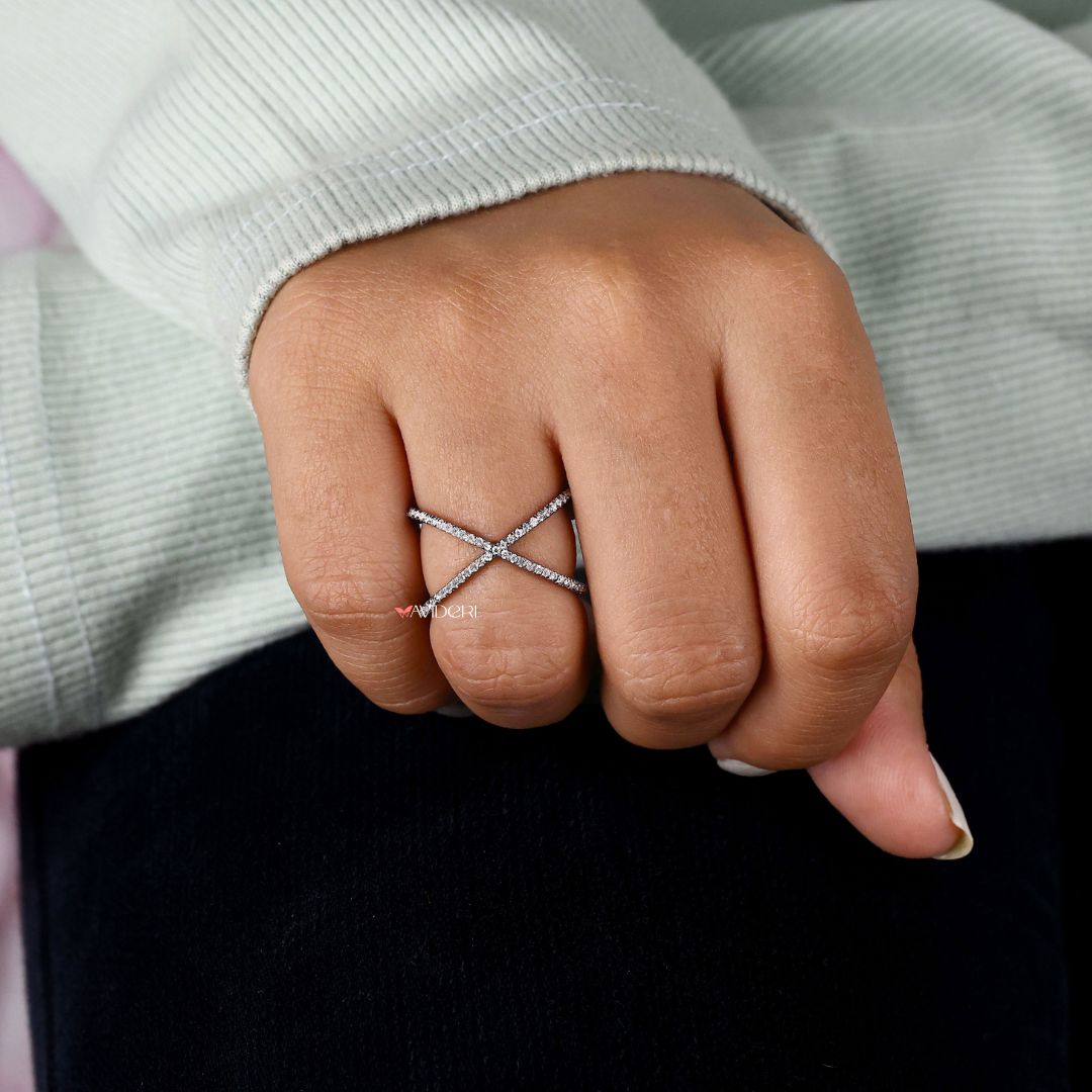 Black band complements moissanite with a dramatic, sophisticated design.