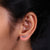 A pair of cartilage stud earrings displayed on a jewelry stand.
 A pair of cartilage stud earrings displayed on a jewelry stand.