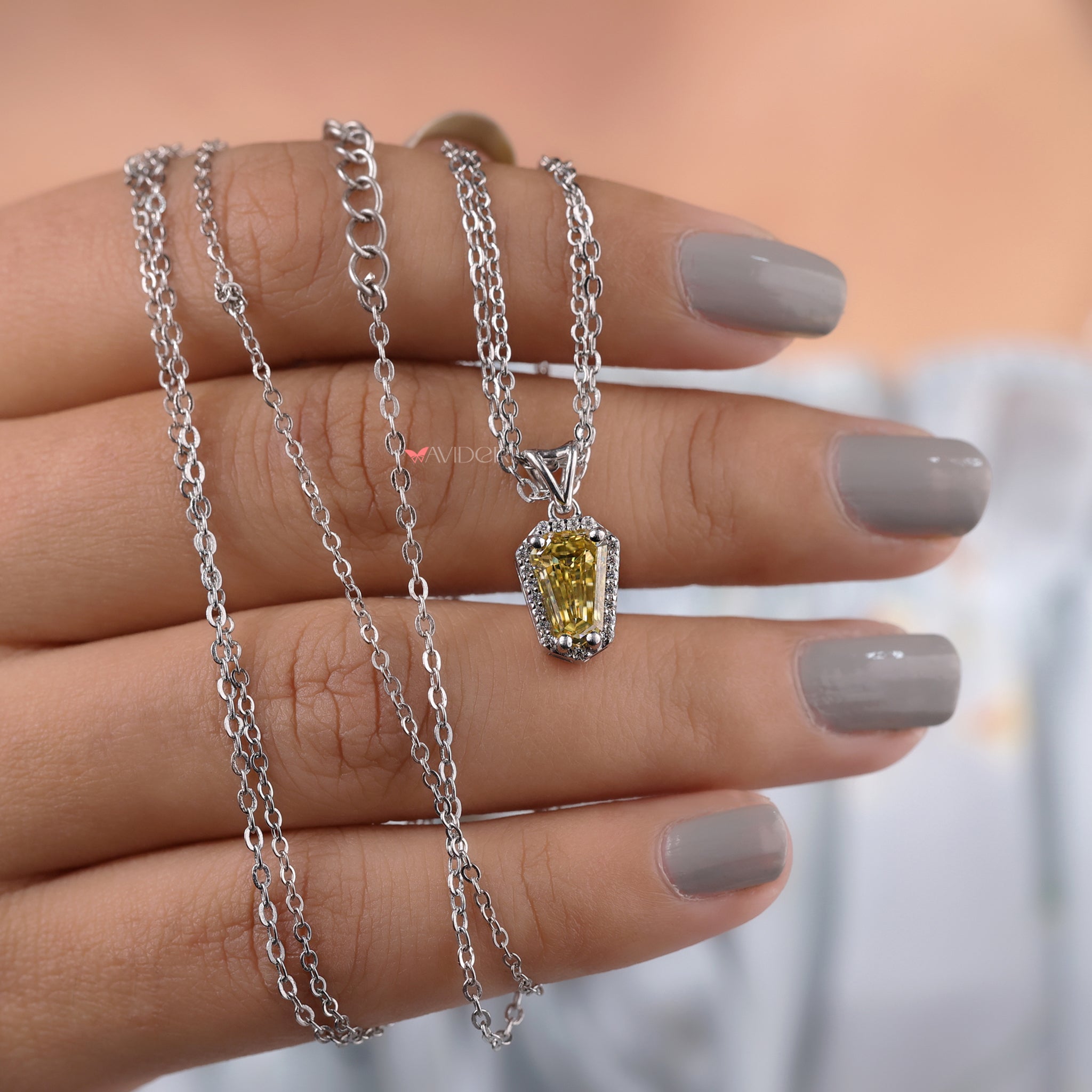 Shield cut moissanite pendant offers radiant brilliance with a distinctive cut.