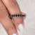 Moissanite eternity band featuring a round cut wedding band design.
 Moissanite eternity band featuring a round cut wedding band design.