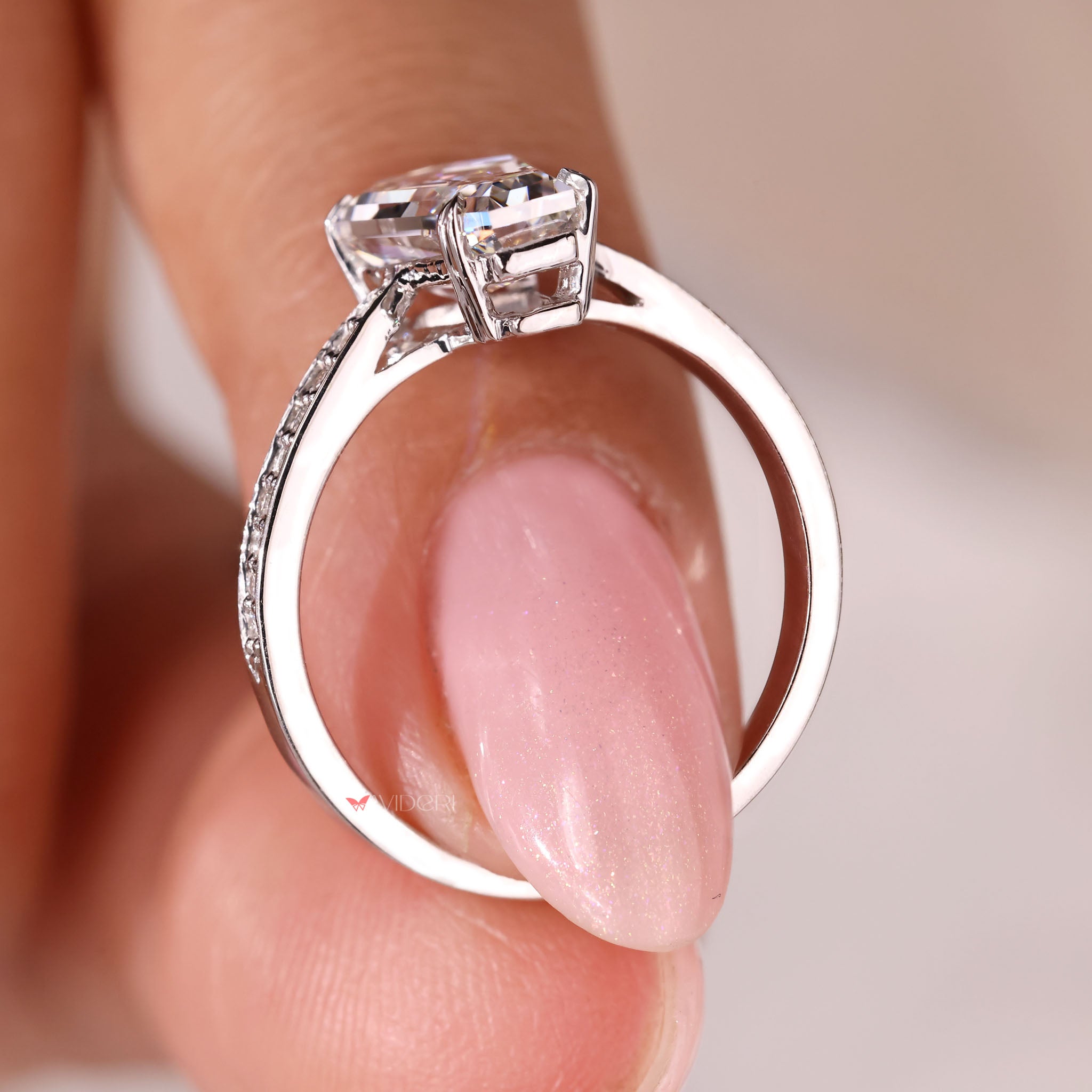 White gold ring with round cut diamond in 4 heart prong setting.