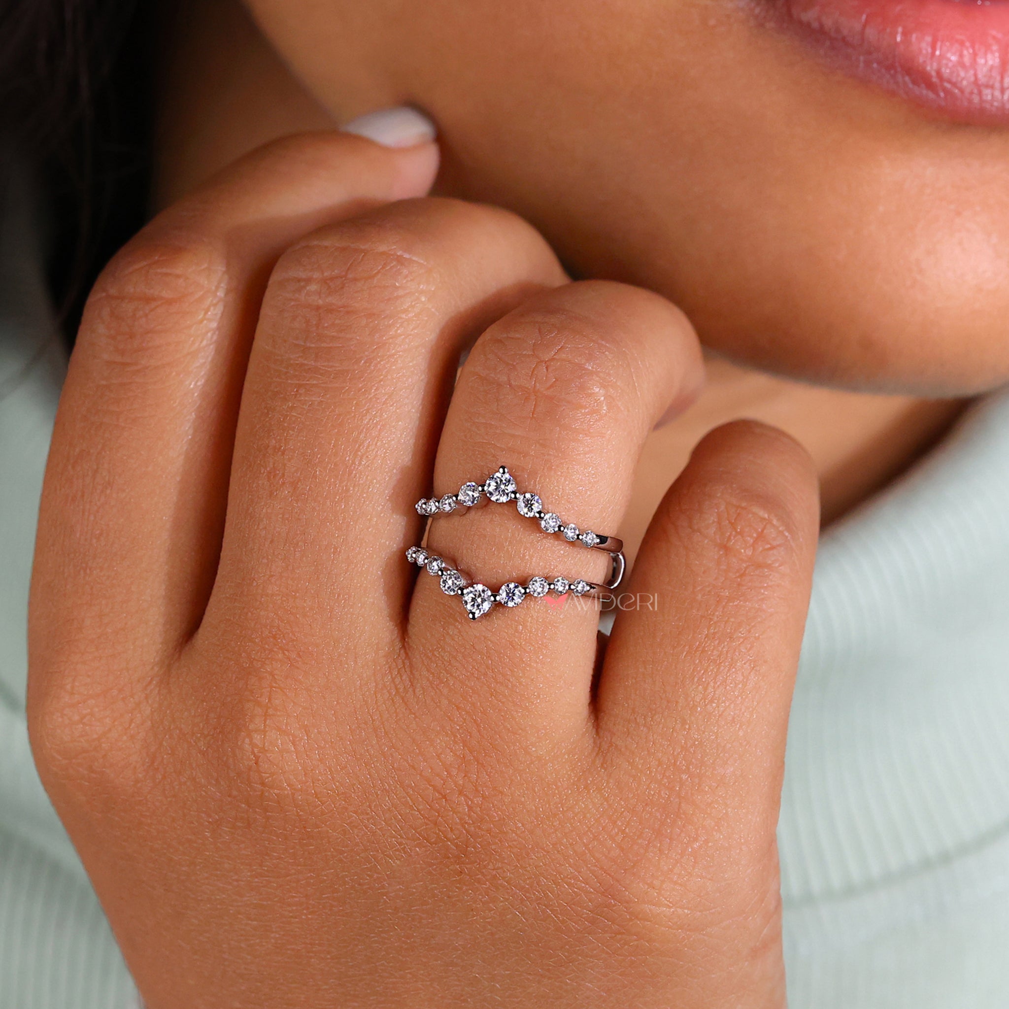 Shared prong band featuring round diamonds.