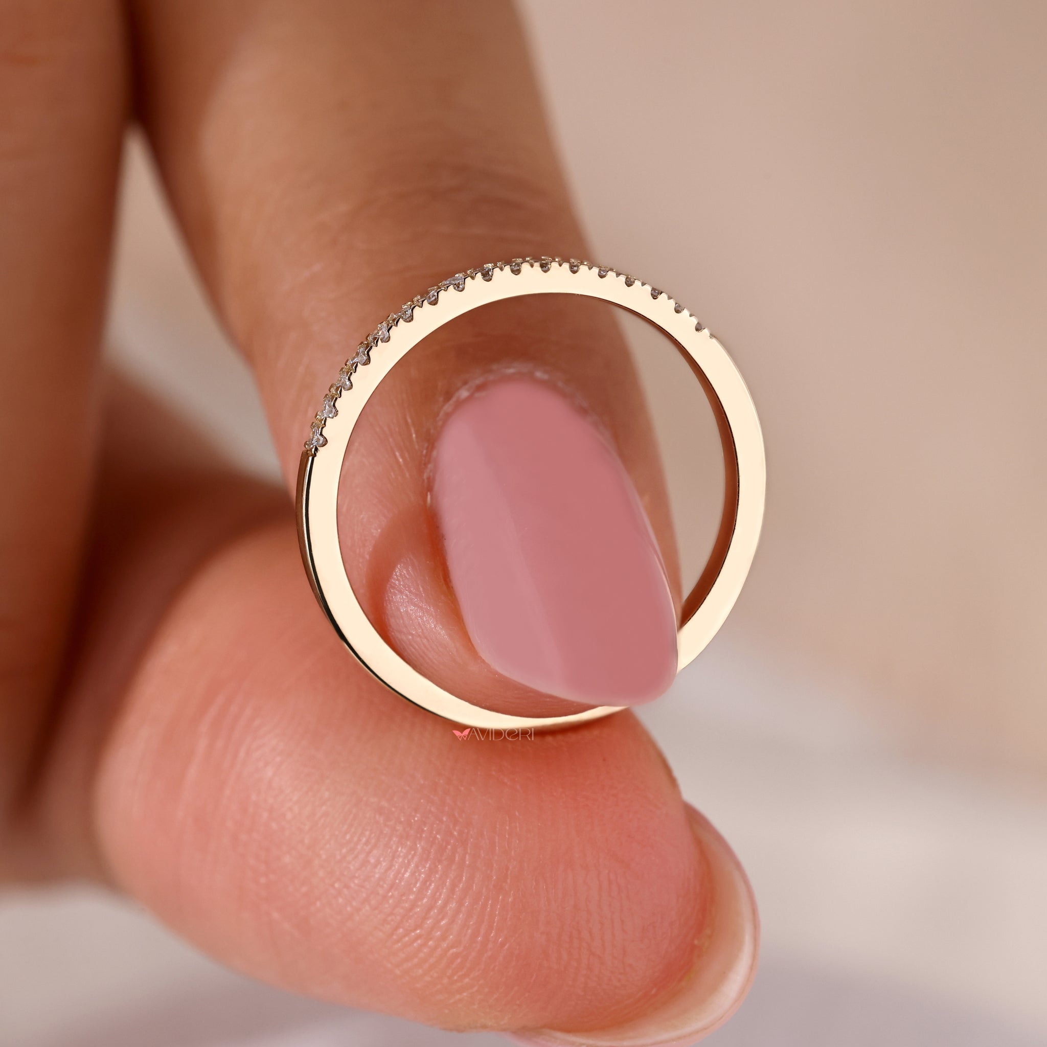 A round diamond eternity band set in yellow gold with a delicate design.