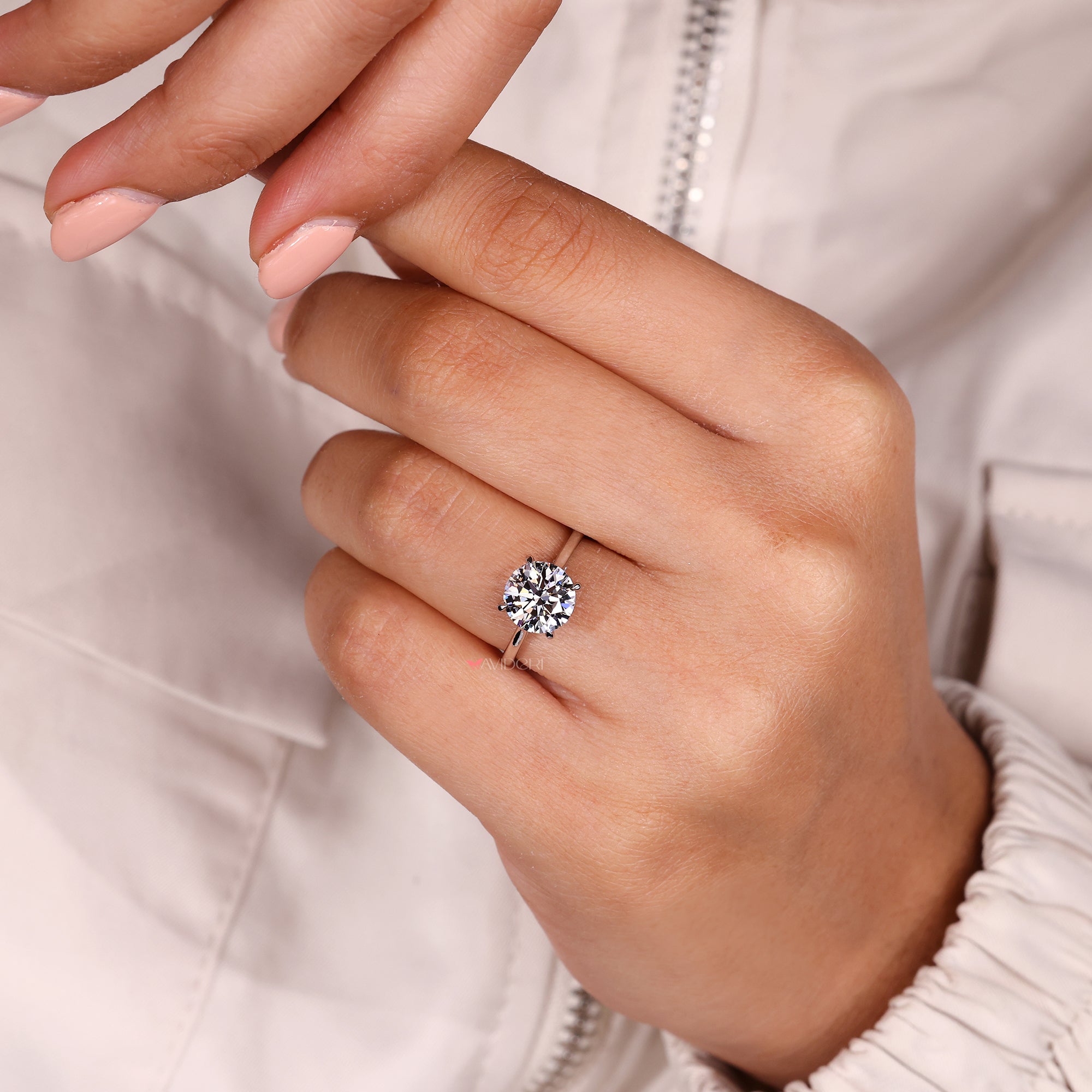 Avideri round diamond ring with cathedral and bridge design.