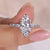 Brilliant marquise diamonds in a sparkling halo setting
 Brilliant marquise diamonds in a sparkling halo setting