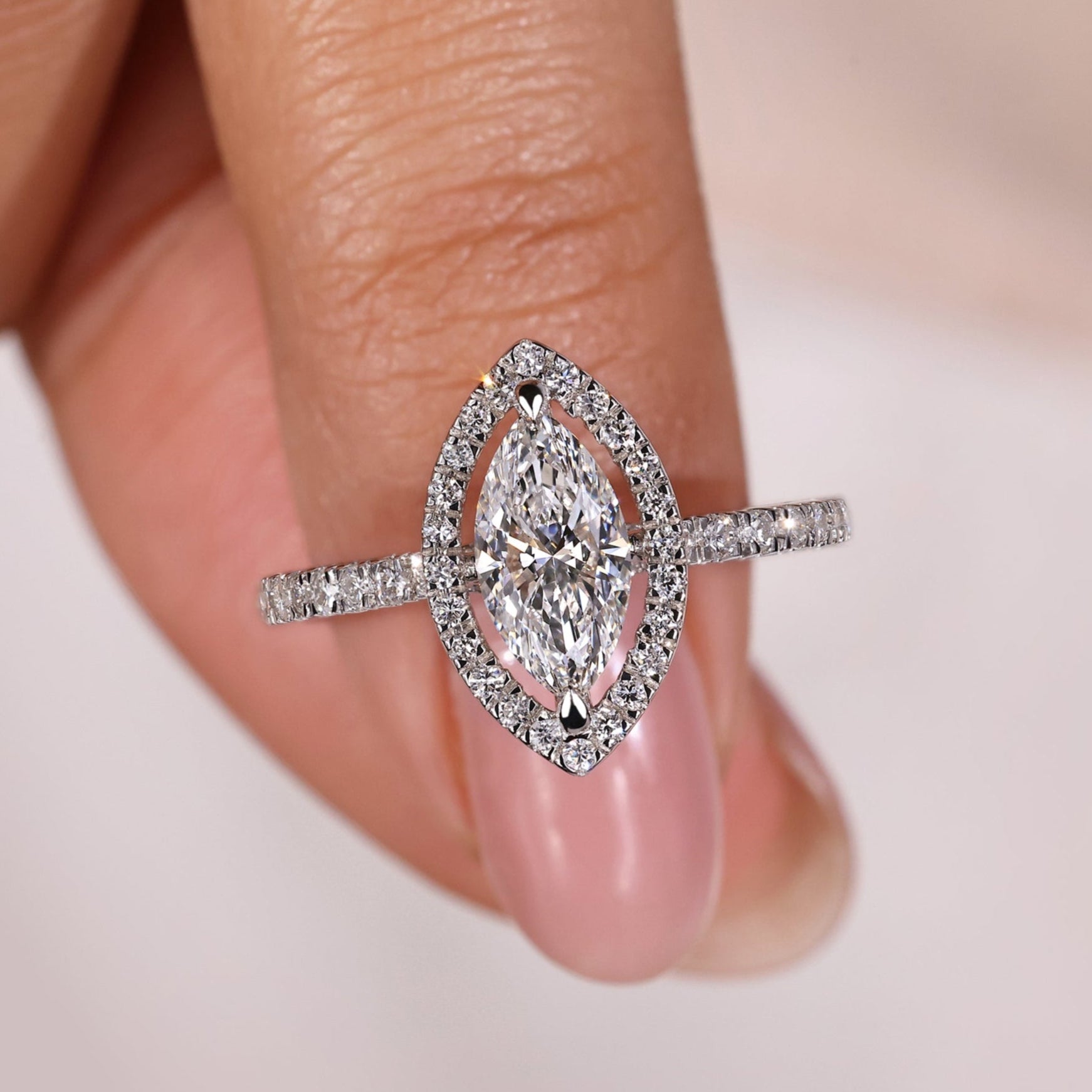 Marquise halo engagement ring with a marquise diamond with halo and pave stones, perfect for timeless elegance.