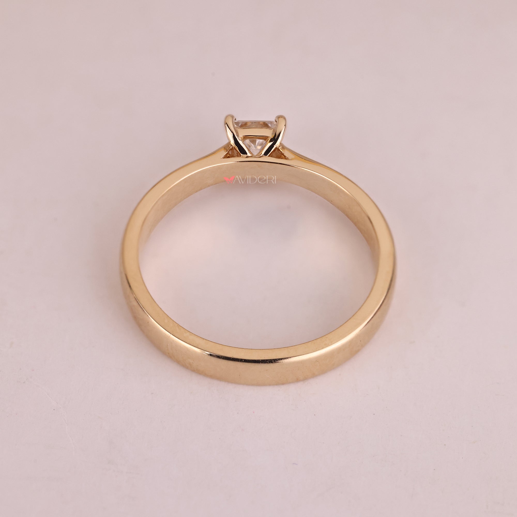 Yellow gold engagement ring with a princess diamond, a practical and stunning choice.
