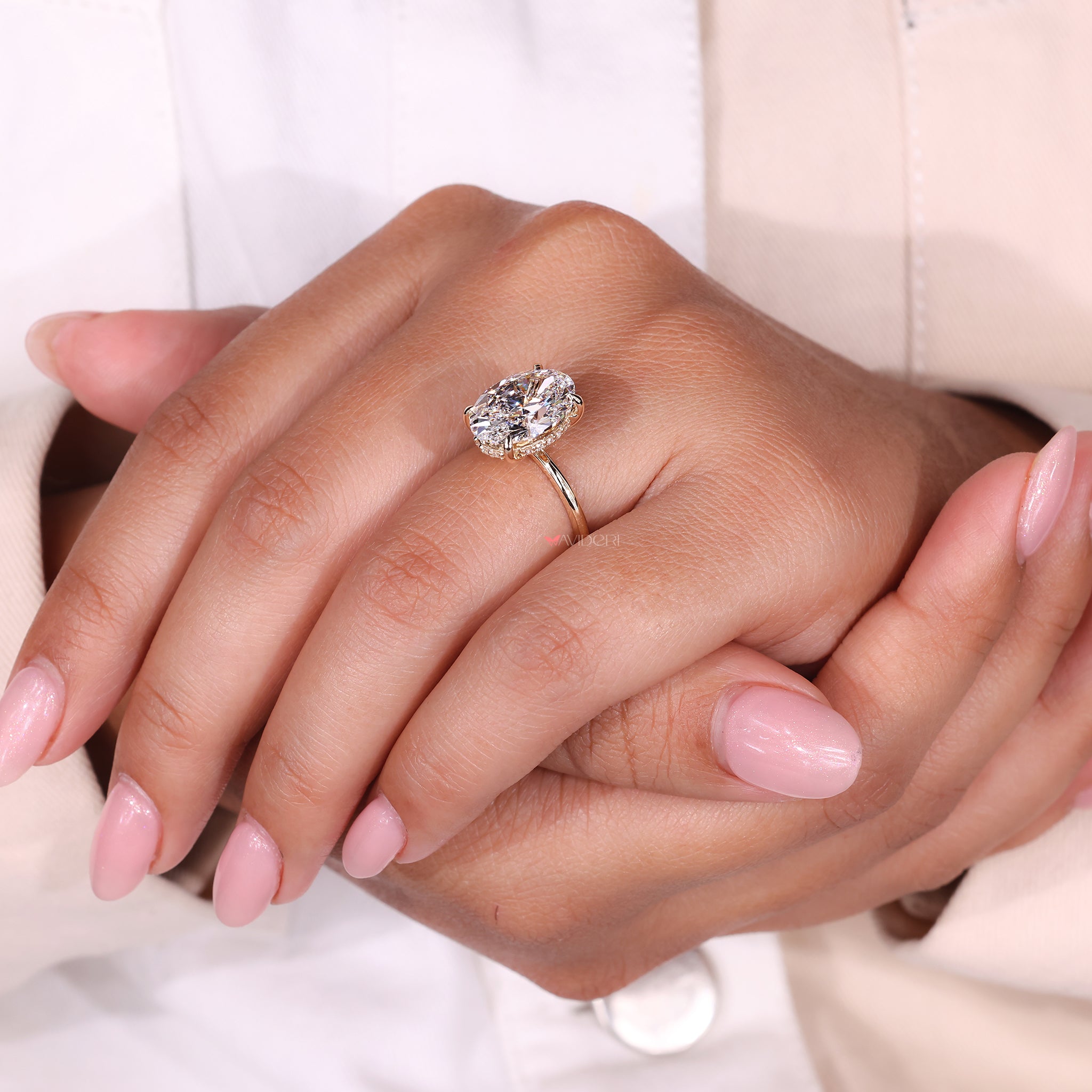 Hidden Halo Ring with an oval cut diamond, enhancing the beauty of the center stone