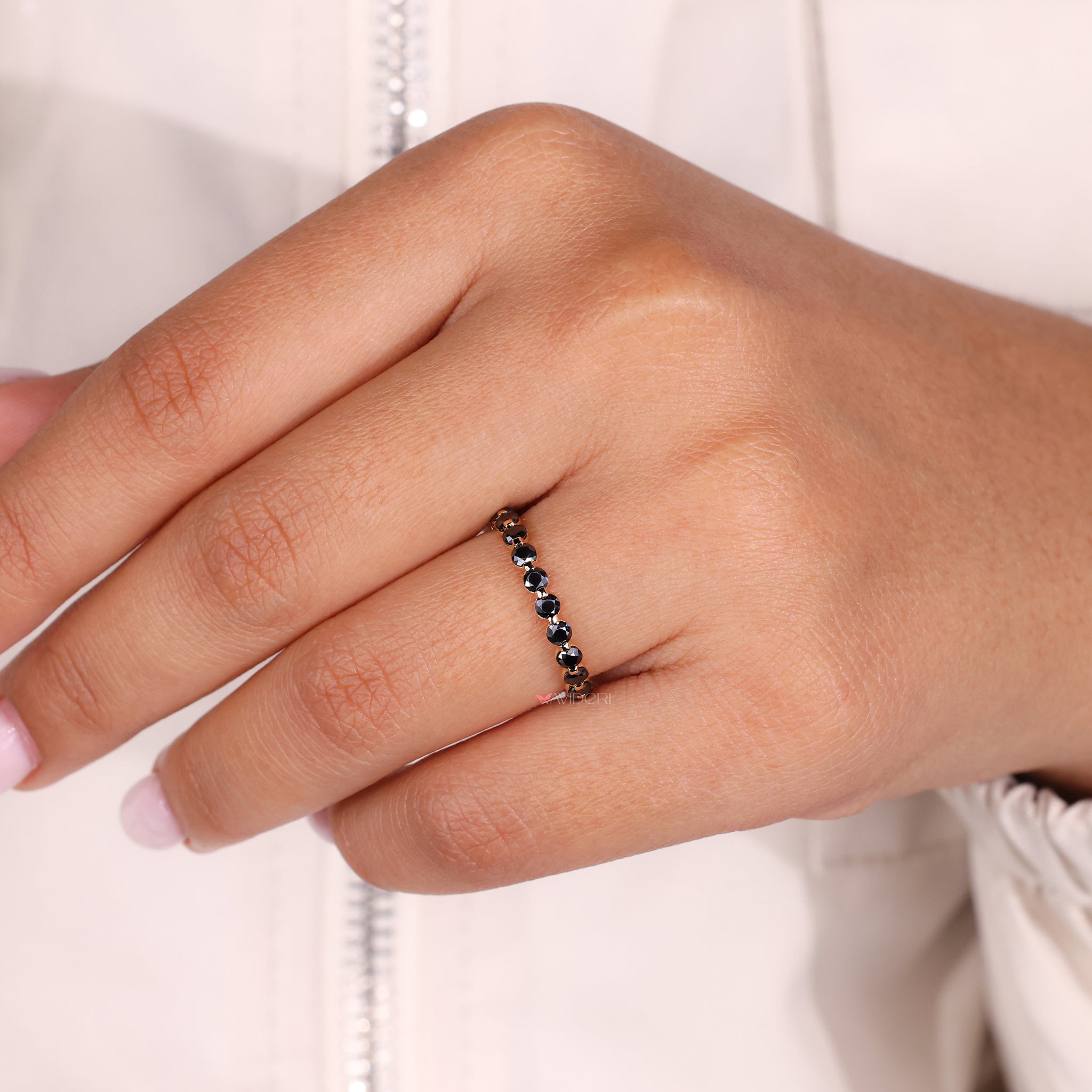 A black moissanite wedding band adds bold contrast and style.