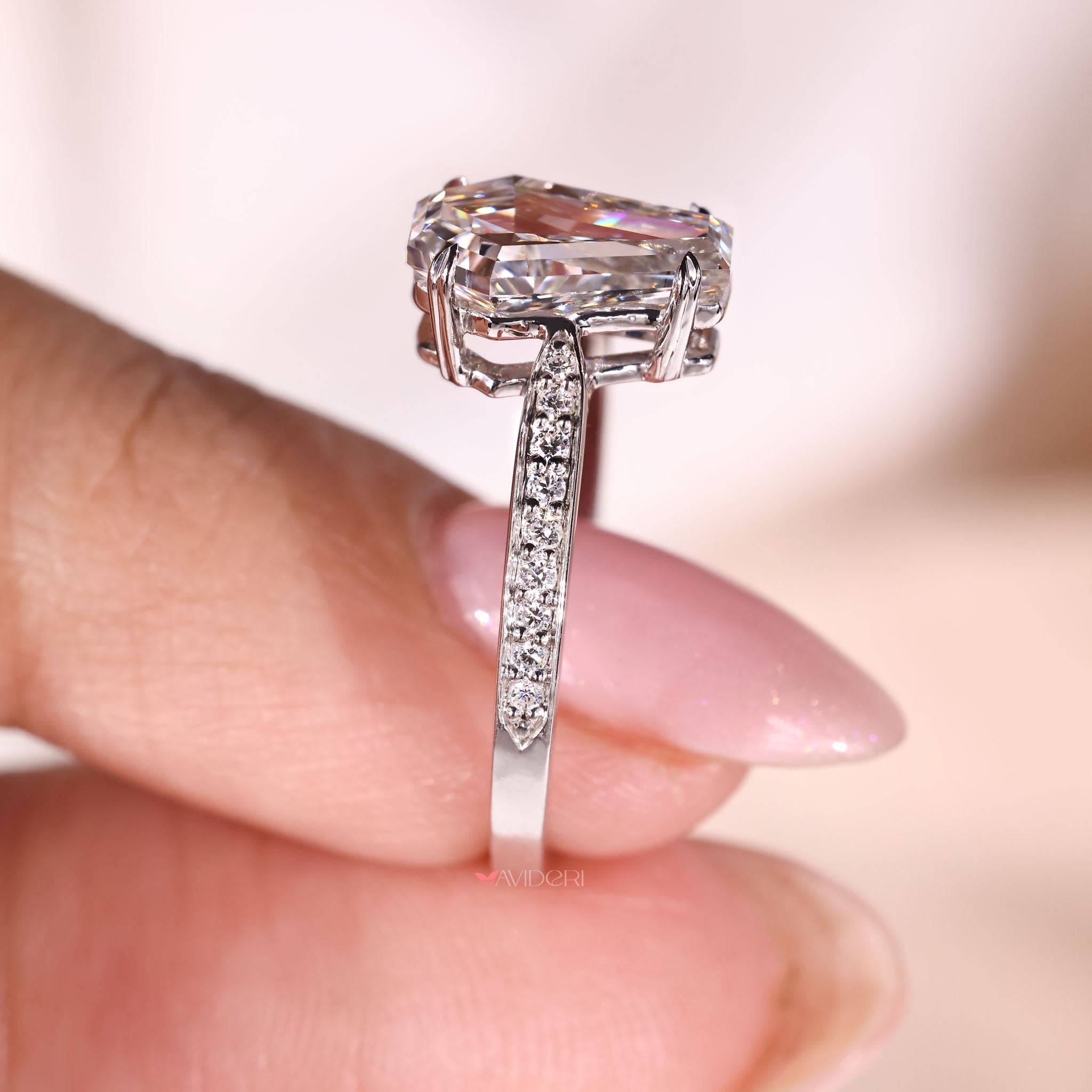 Round cut diamond in cathedral setting with 4 heart prong design.