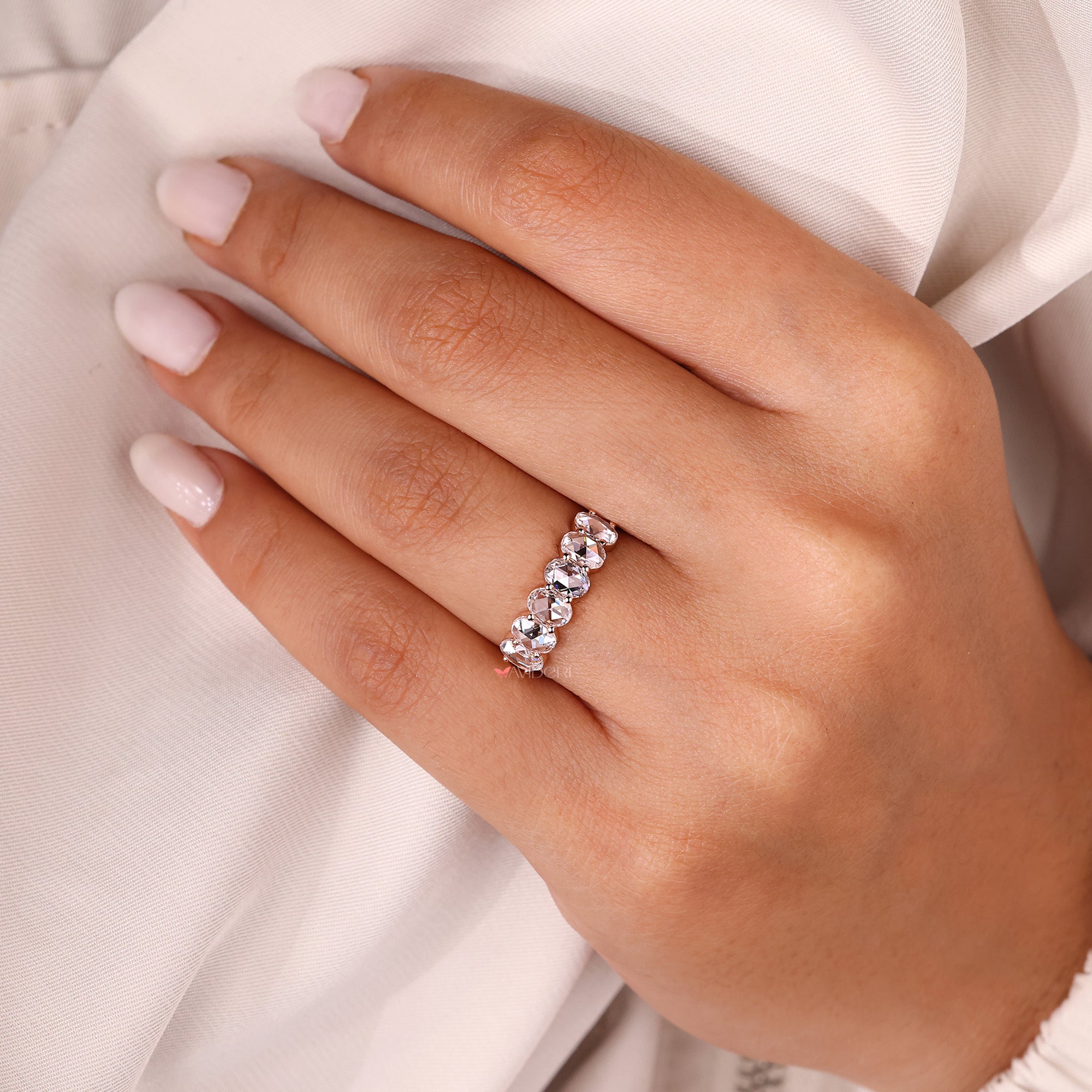 Oval diamond wedding band with six stone setting.