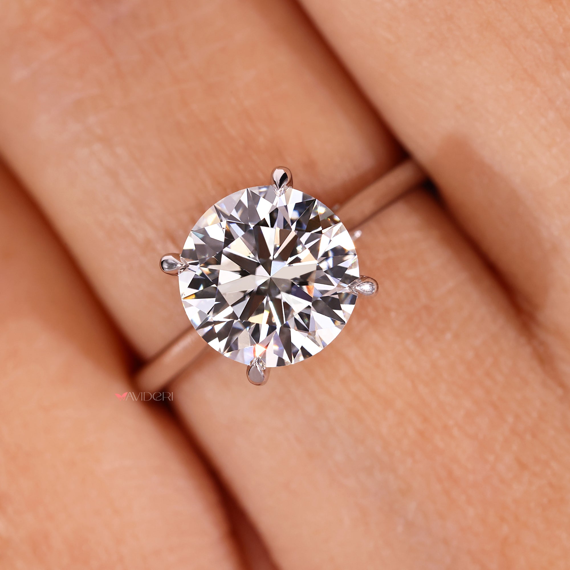 Four claw prong set round diamond ring with tapered band.