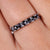 A black moissanite wedding band shines with bold elegance. A black moissanite wedding band shines with bold elegance.