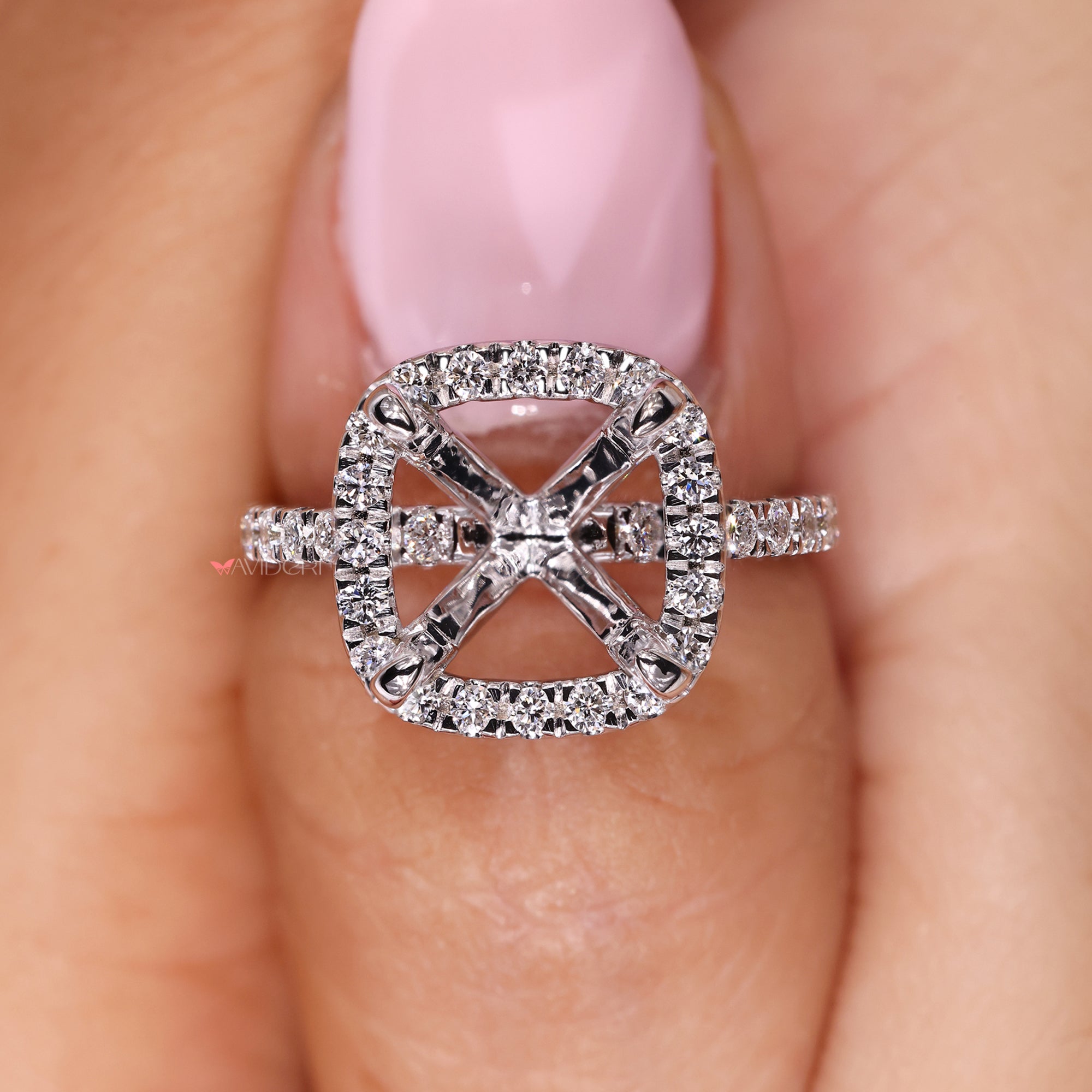 Mount for cushion cut diamond in pave halo setting.