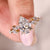 Pear diamond ring with a marquise and round side diamond layout in yellow gold.
 Pear diamond ring with a marquise and round side diamond layout in yellow gold.