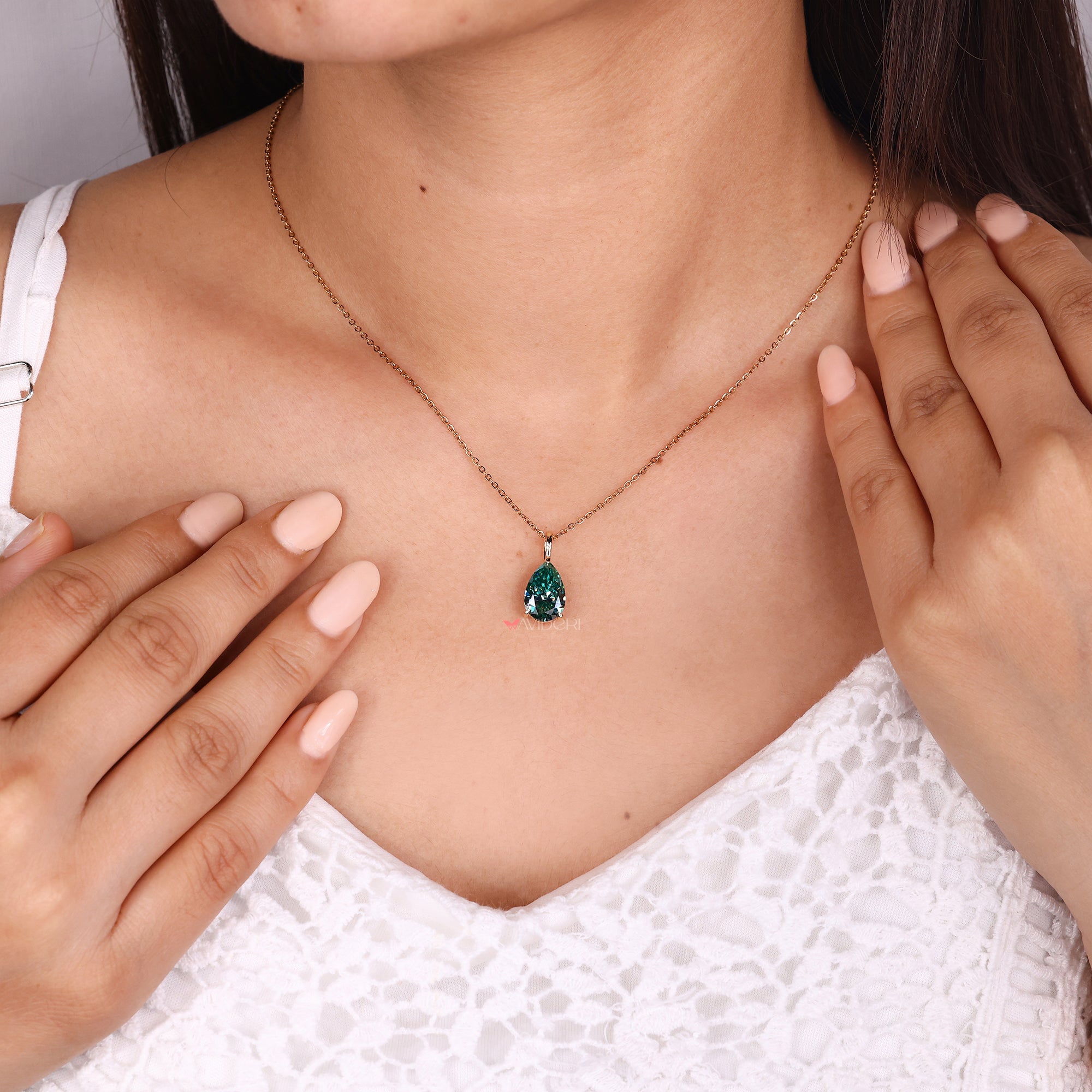 Teardrop moissanite pendant with handmade design.