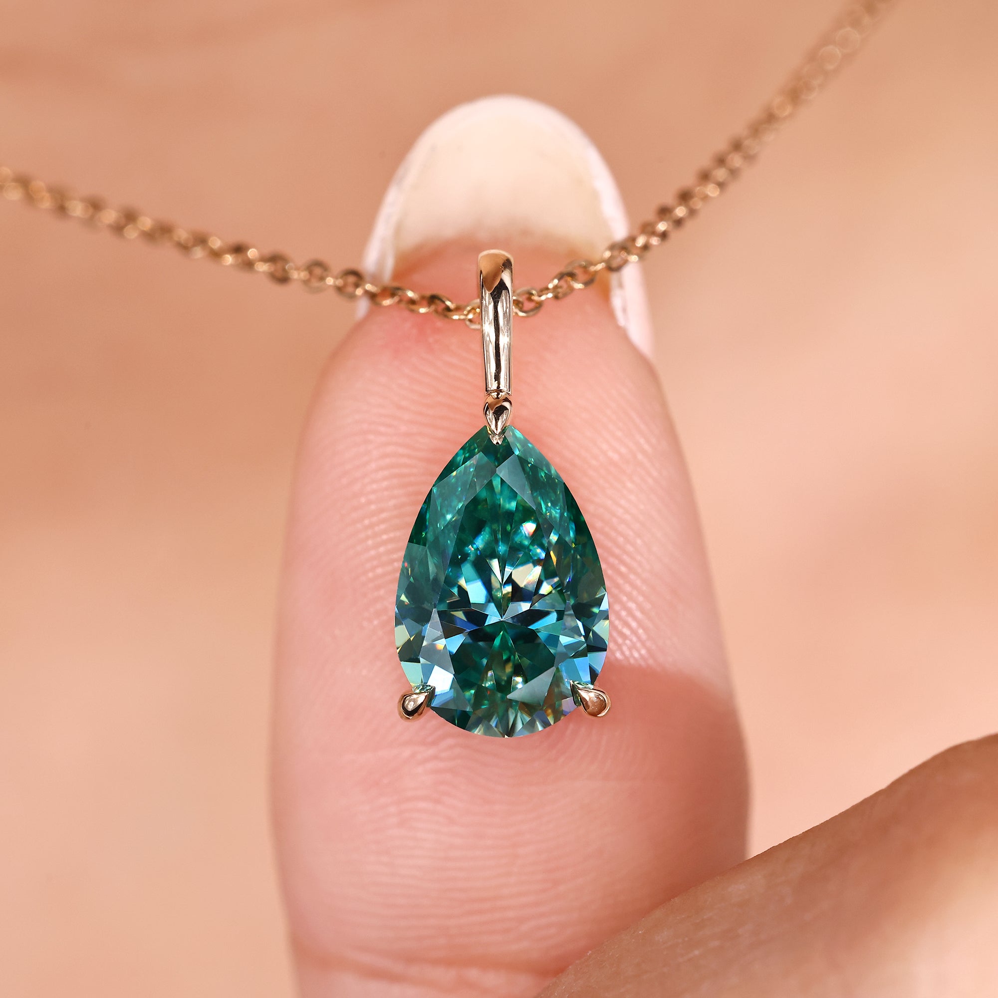 Cyan blue moissanite pendant in pear shape.