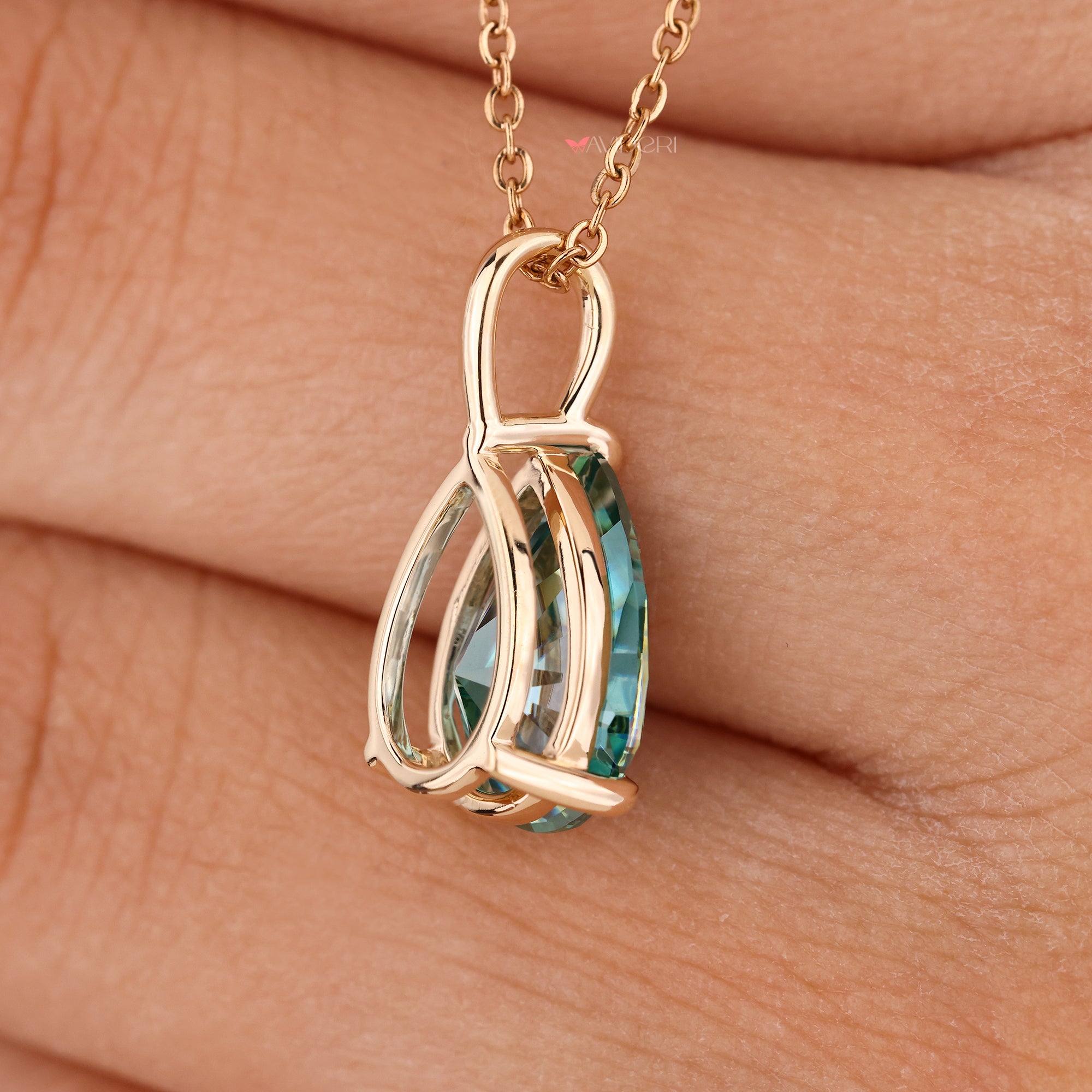 Yellow gold pendant with pear shape moissanite.