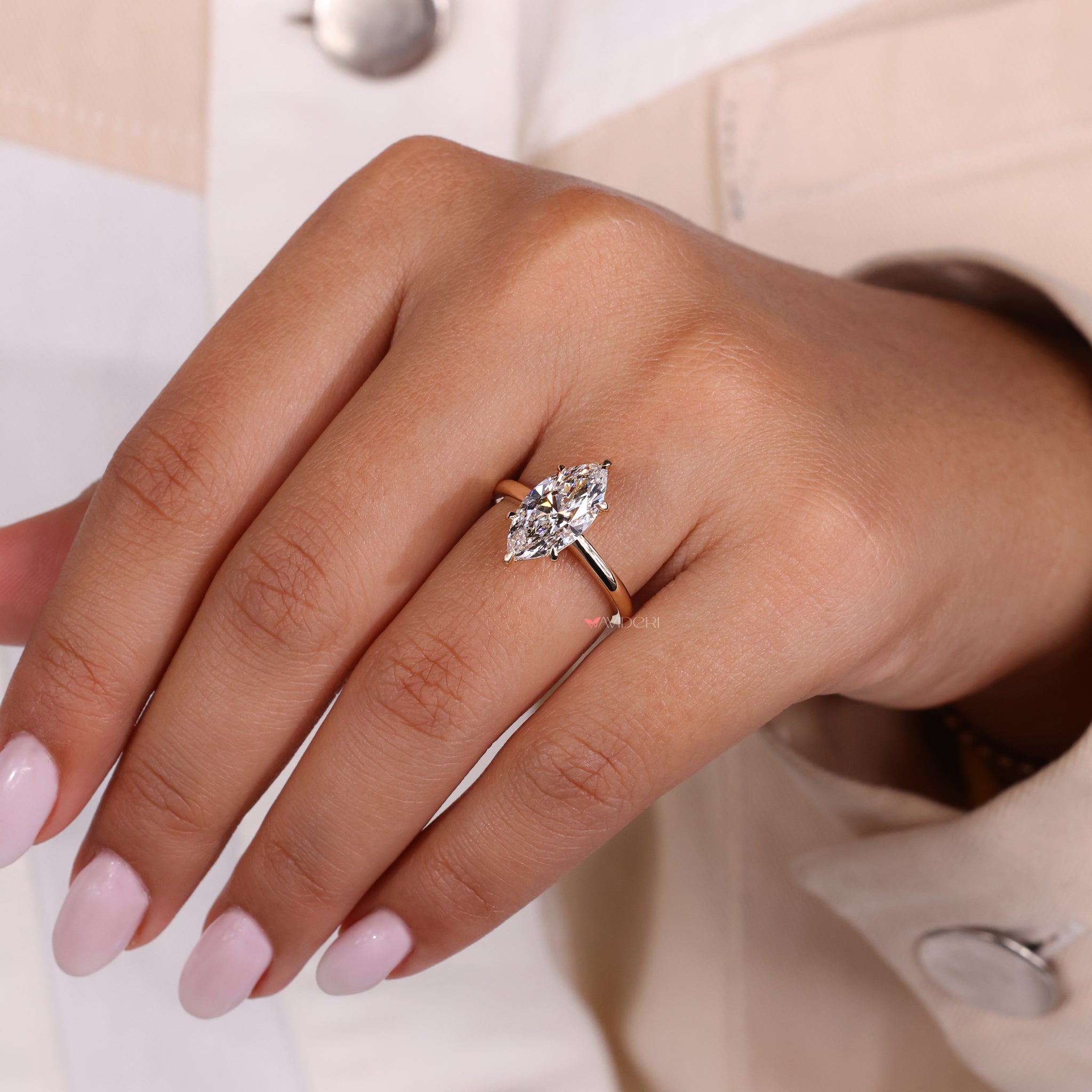 Claw prong ring with a Marquise diamond for enhanced sparkle.