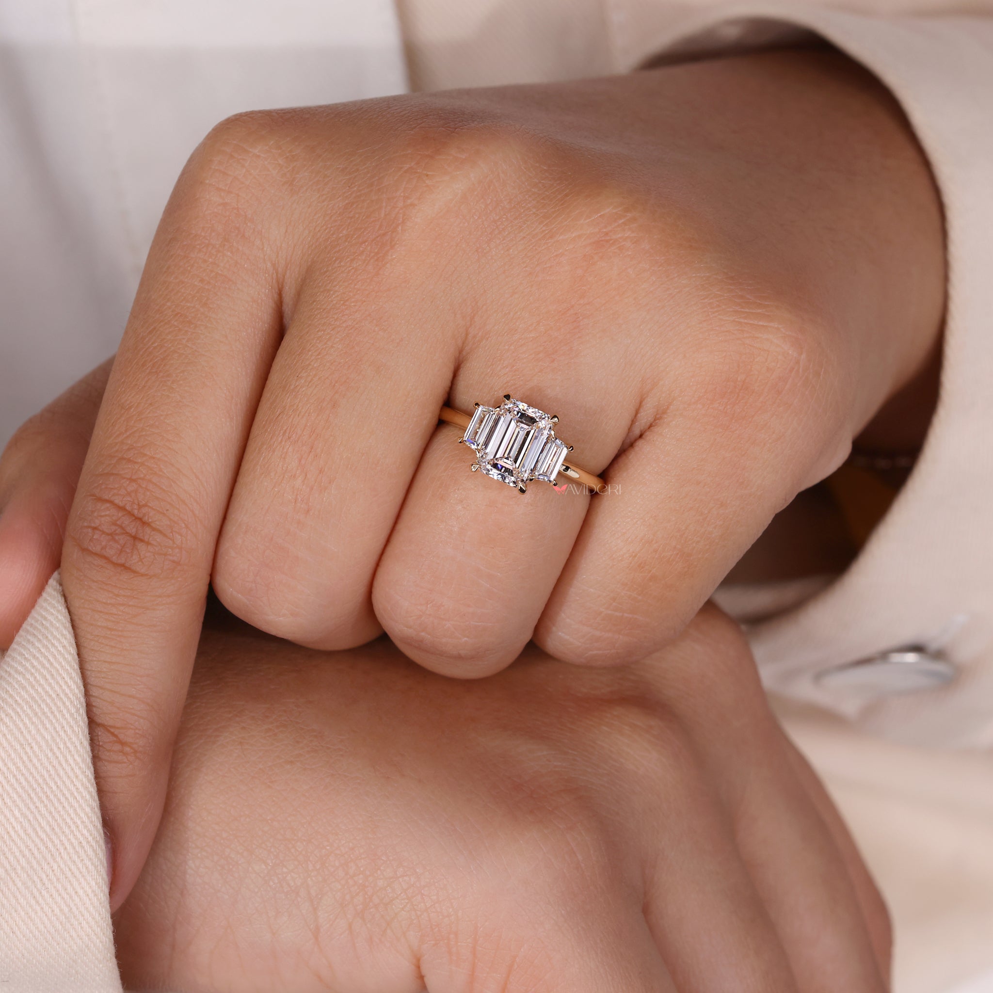 Three stone wedding ring with an emerald cut diamond for timeless elegance.