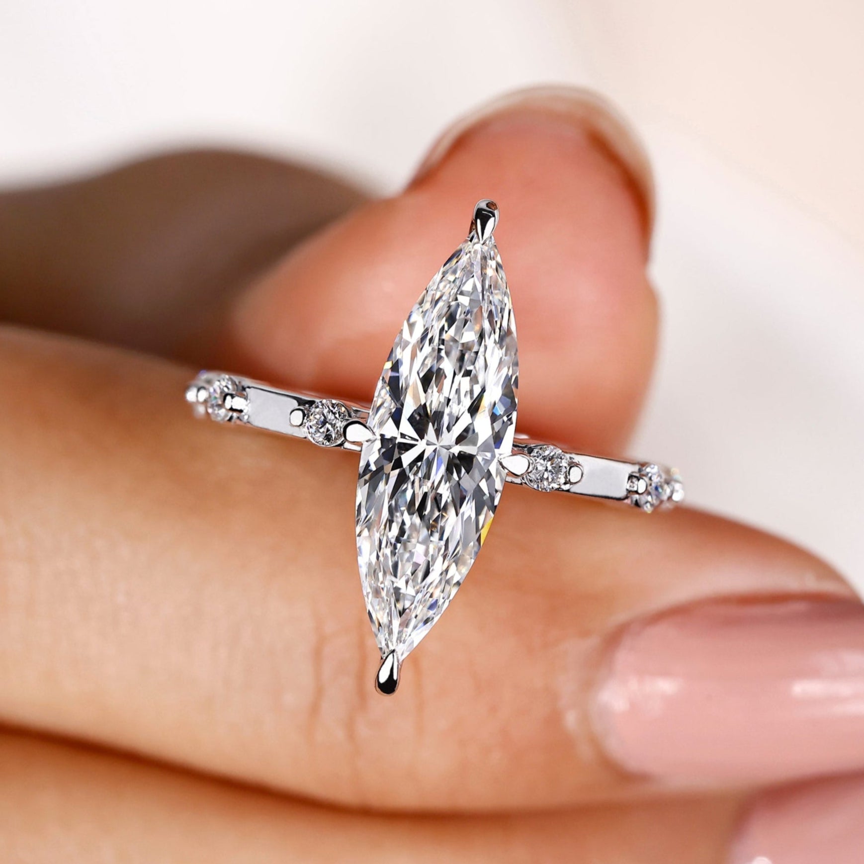 Marquise diamond engagement ring with a compass prong setting.