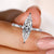 Marquise diamond engagement ring with a compass prong setting.
 Marquise diamond engagement ring with a compass prong setting.