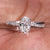 Twisted engagement ring with an oval cut diamond and pave diamond ring design for a modern and elegant look.
 Twisted engagement ring with an oval cut diamond and pave diamond ring design for a modern and elegant look.