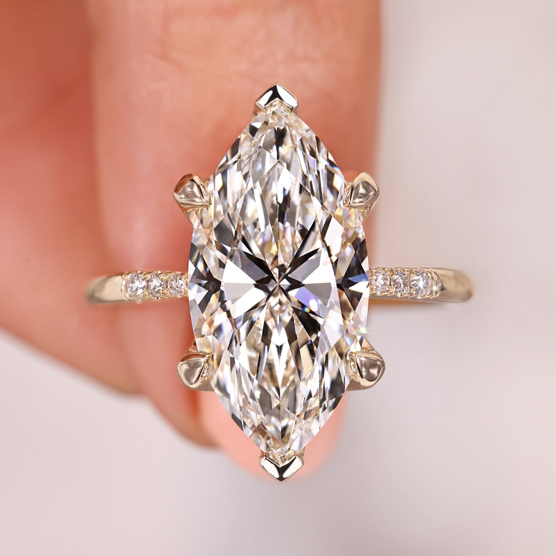 Marquise diamond engagement ring featuring a tapered shank.