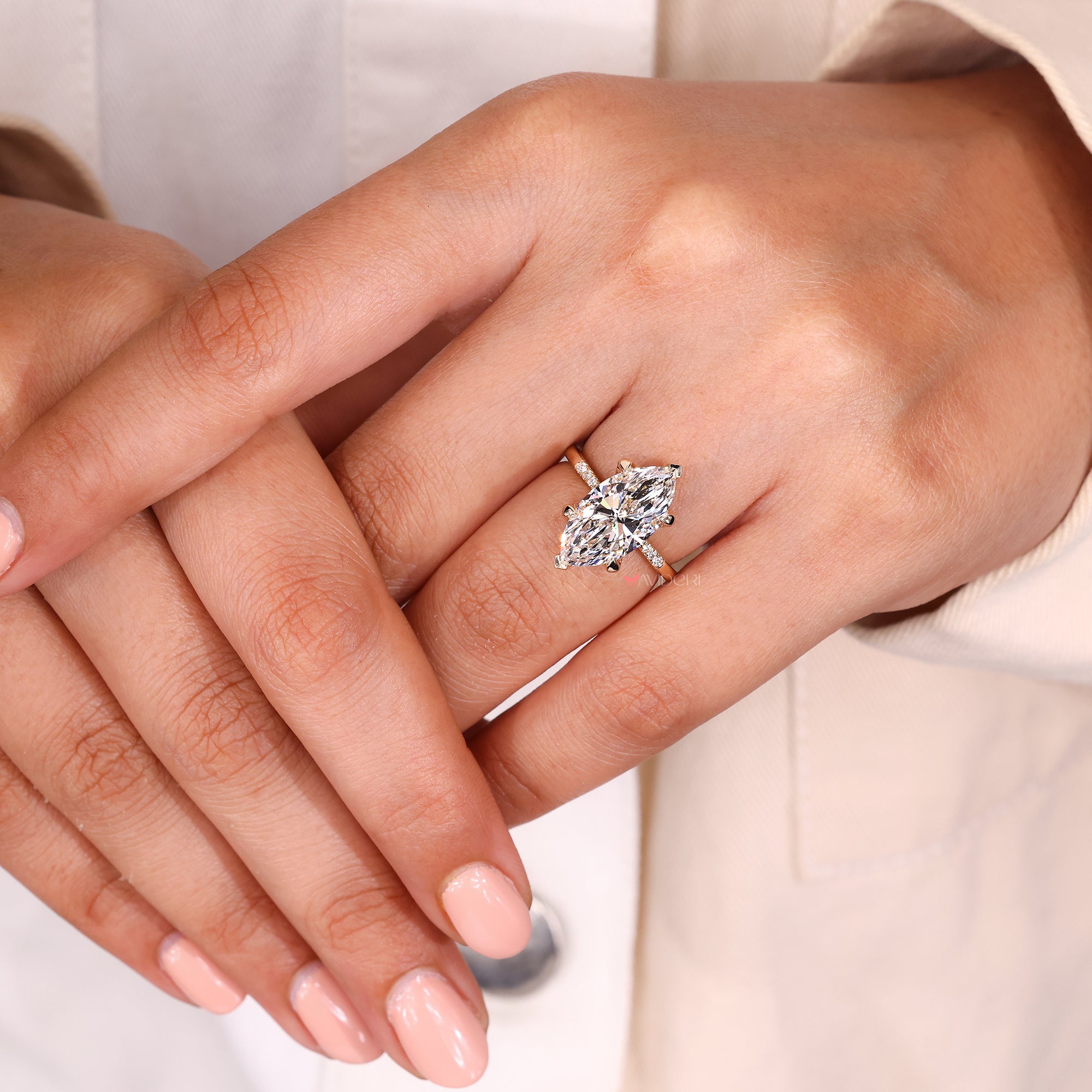 Custom marquise cut ring with round accent stones.