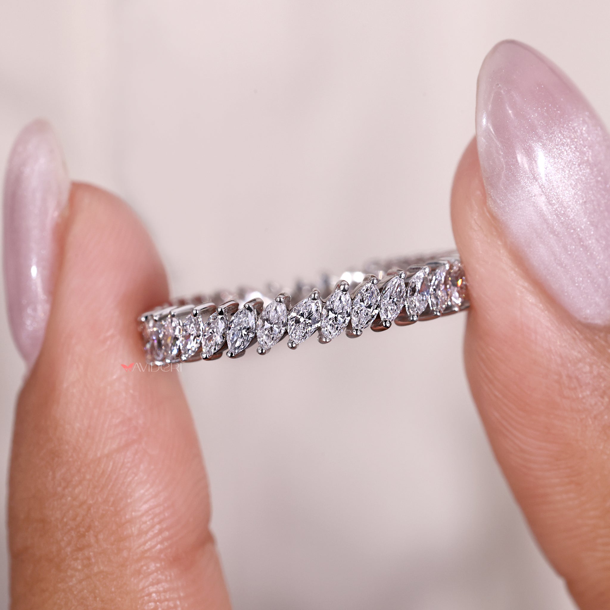 Marquise shape adds graceful point to the wedding band.