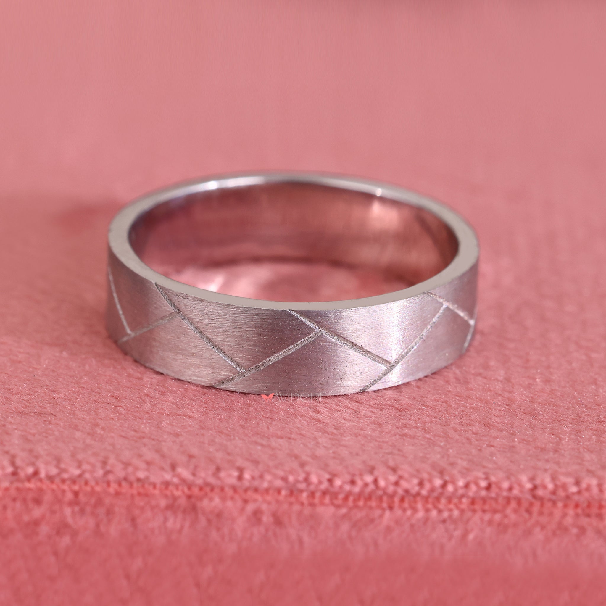 Simple mens wedding band keeps focus on clean, minimal form.