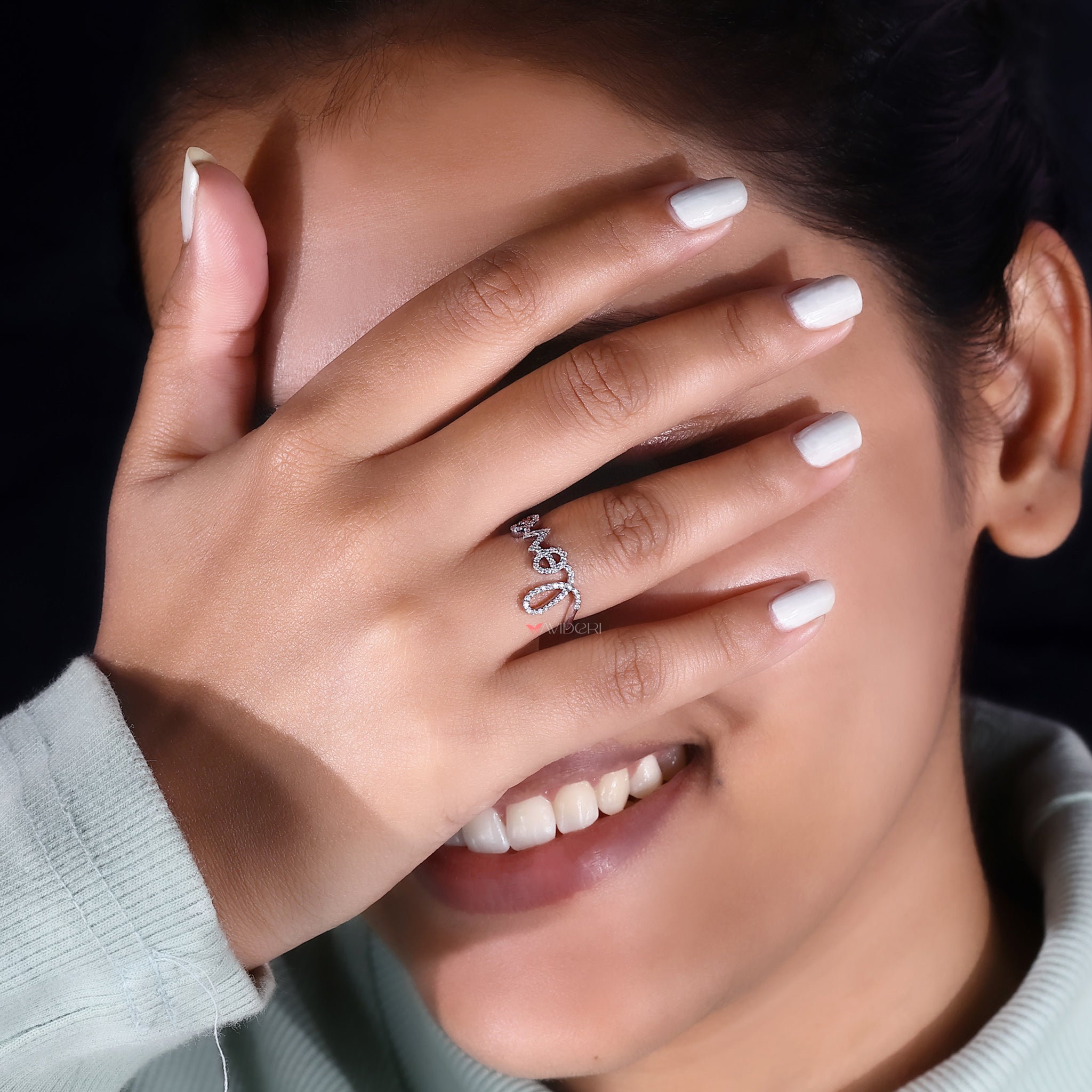An elegant shot features the love letter ring in focus.