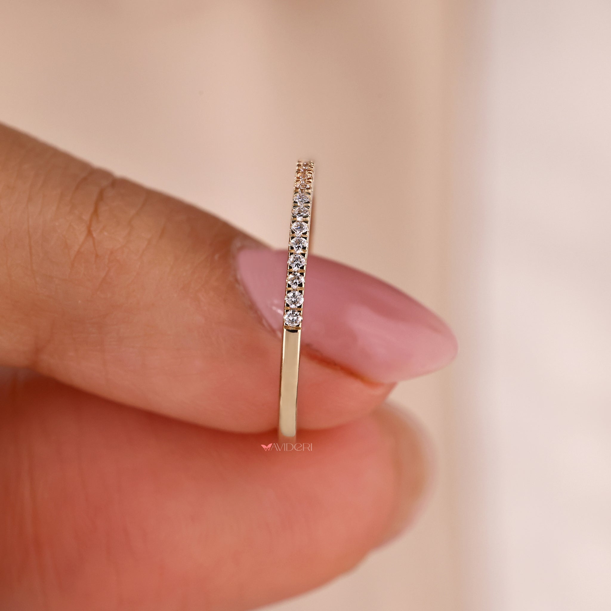 A luxurious yellow gold wedding band with diamonds intricately set in a micro pave design.