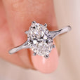 Solitaire oval diamond engagement ring with six claw prong in white gold.