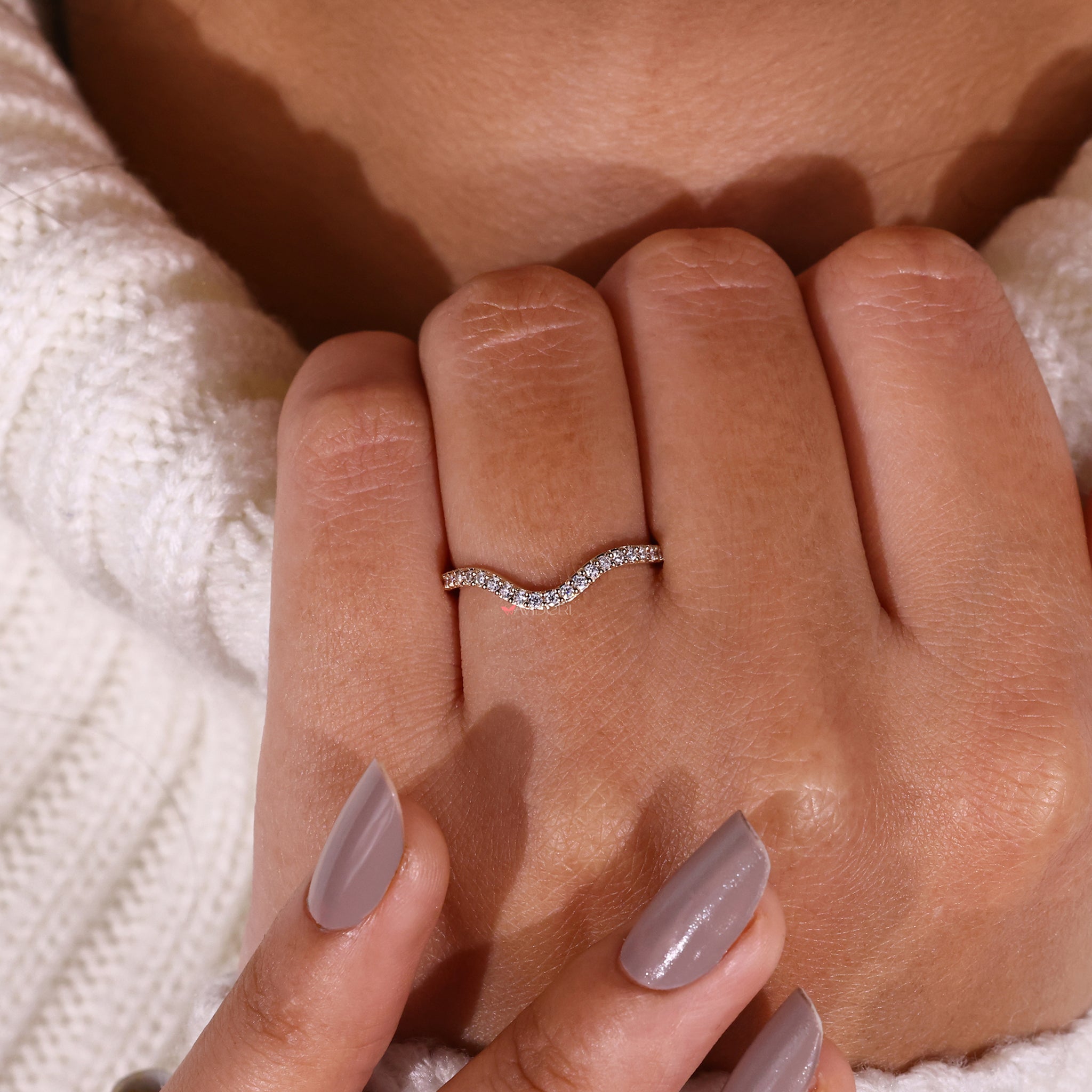 Stunning curved gold wedding band with round cut diamond wedding band for added brilliance.