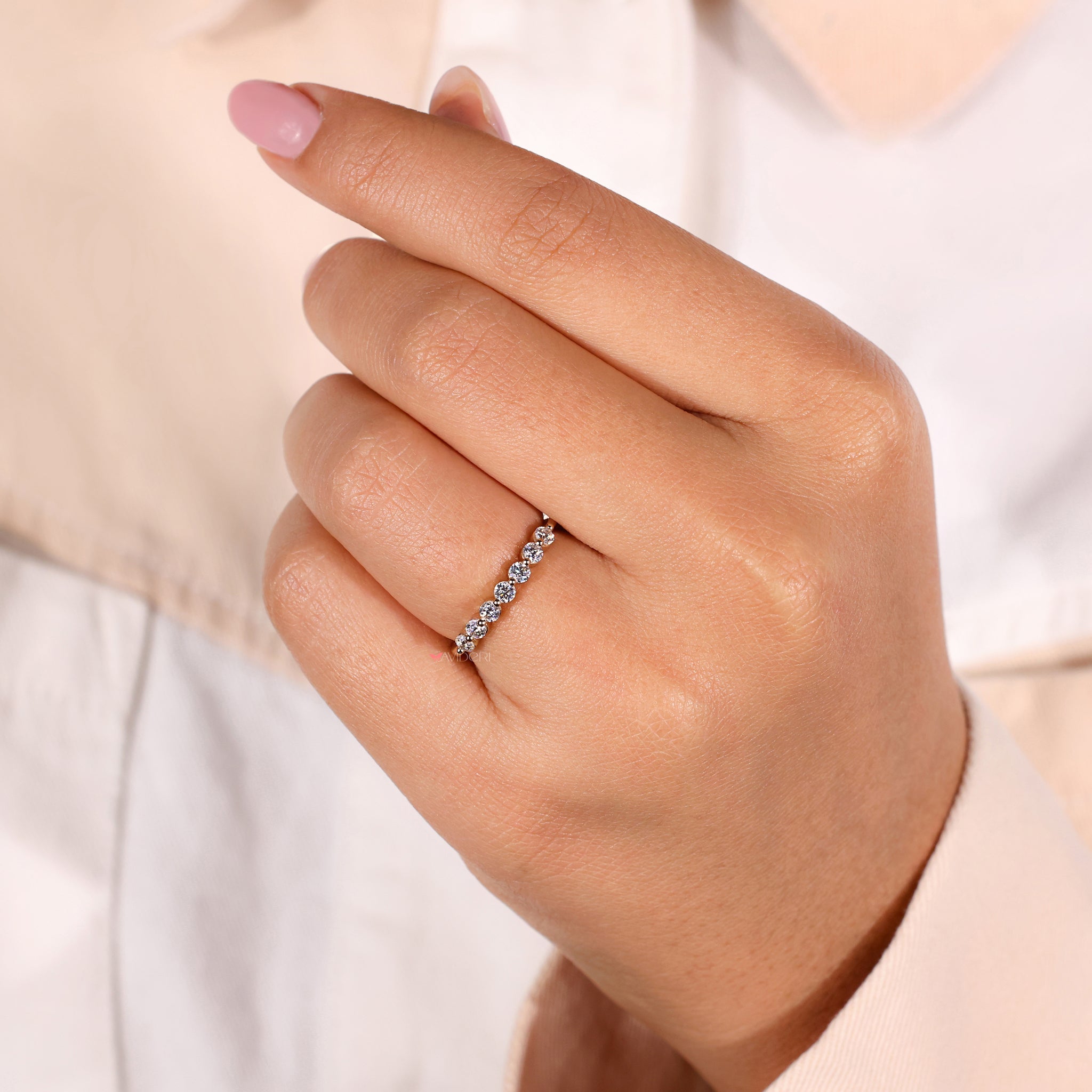 A delicate half eternity diamond ring perfect for adding elegance to any outfit.