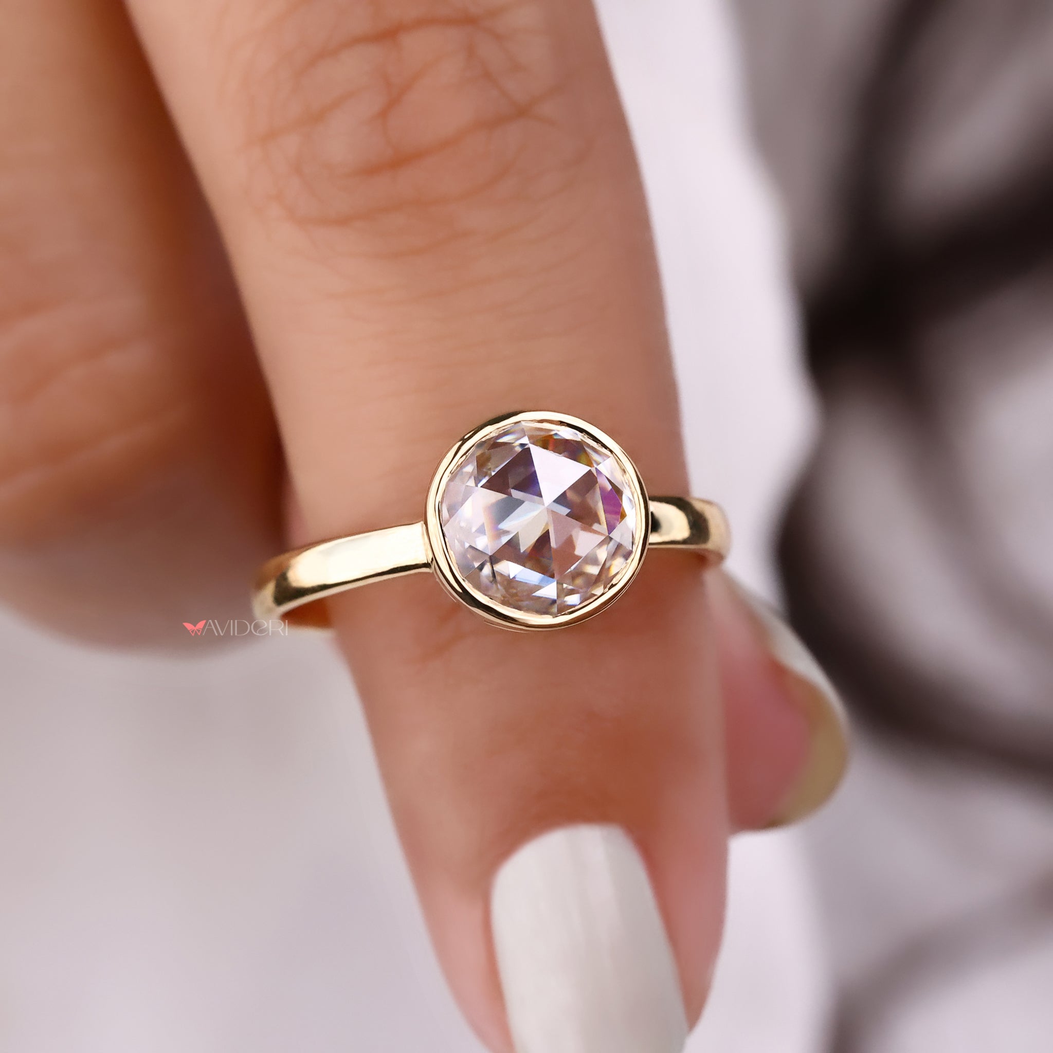 Bezel setting ring with a smooth, modern design that highlights the center stone securely.