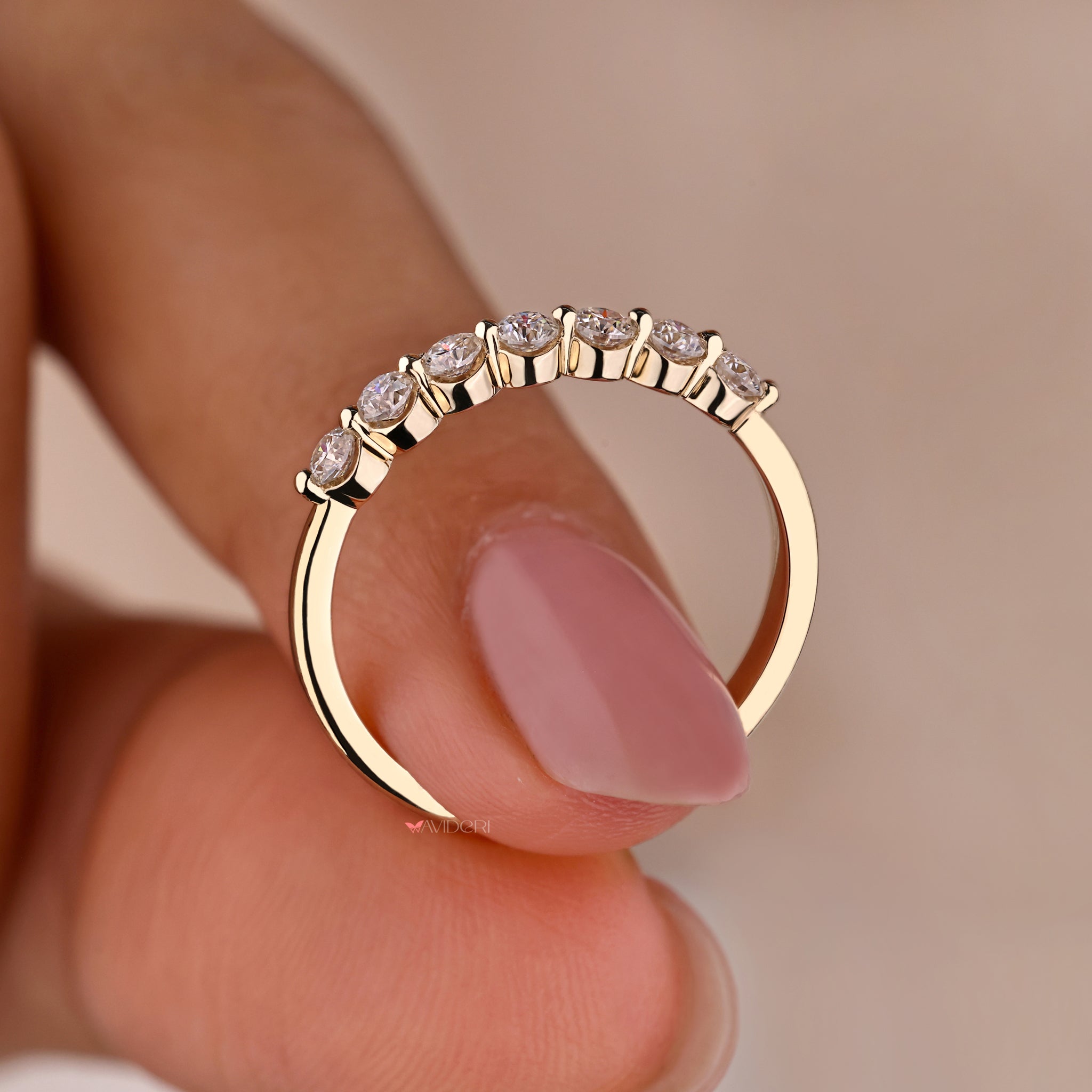 Exquisite Yellow gold diamond wedding band with a shared prong design for extra sparkle.