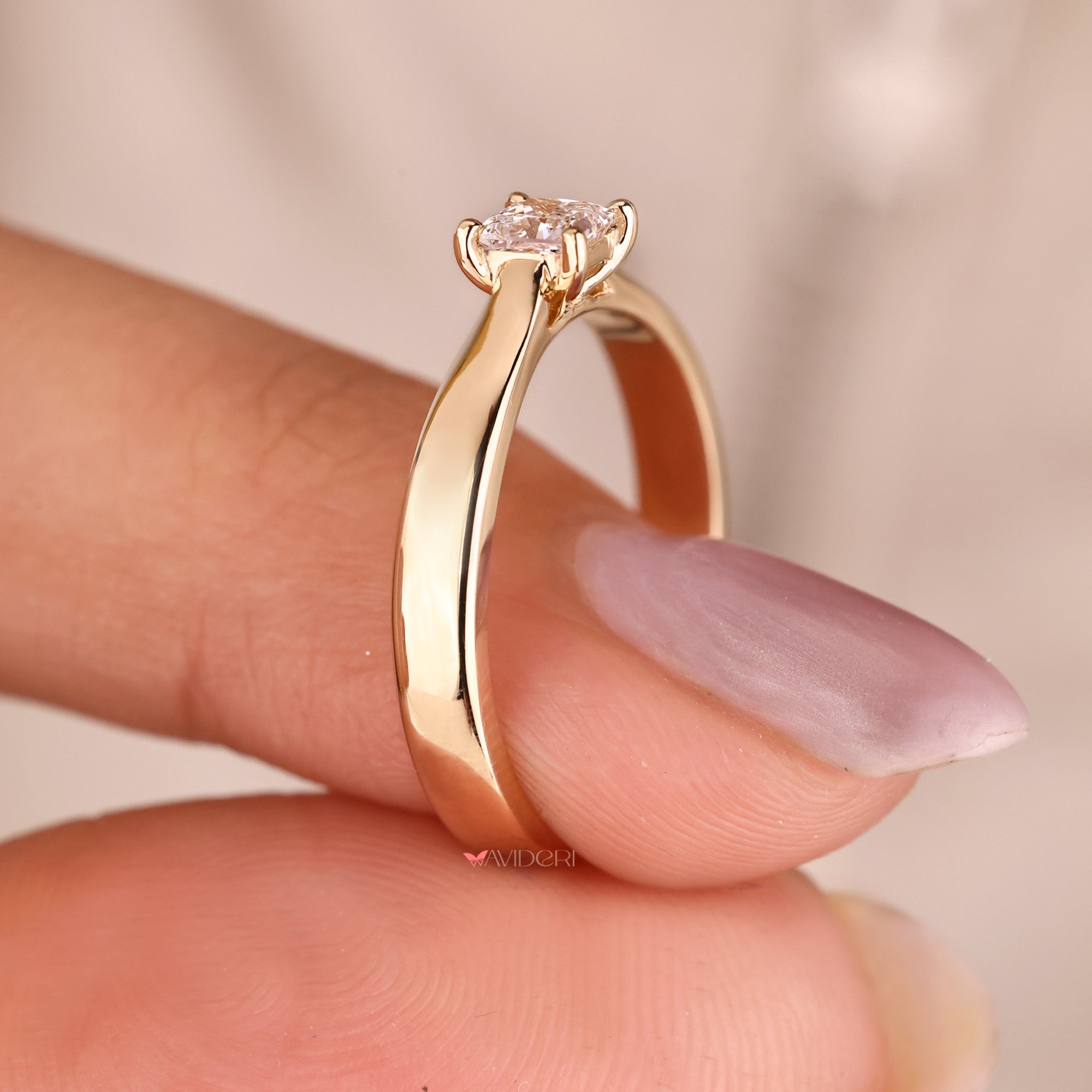 Solitaire diamond engagement ring with a tapered shank, perfect for a streamlined style.