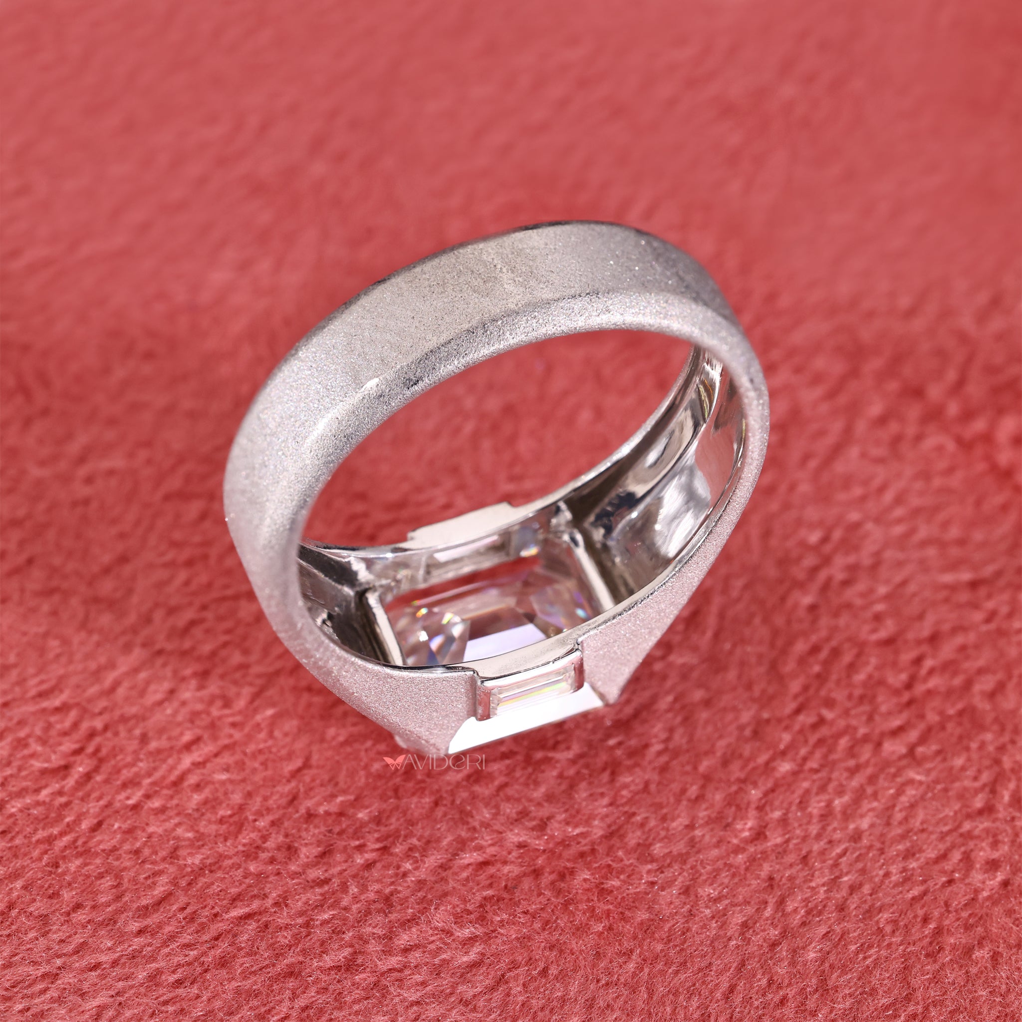 Emerald and baguette three diamond ring makes a stunning choice for a wedding band.