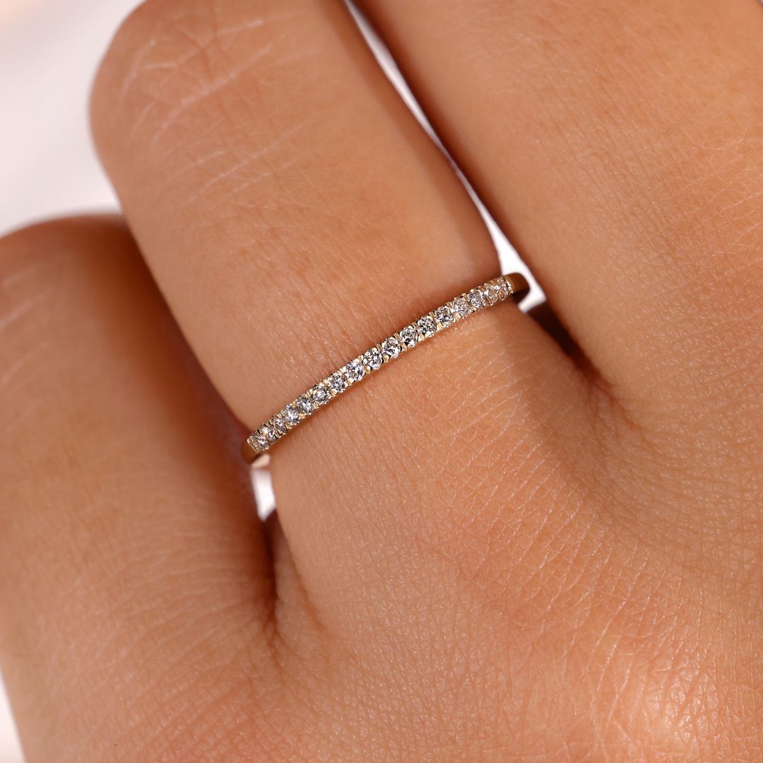 A thin diamond wedding band featuring micro pave diamonds, perfect for elegant weddings.