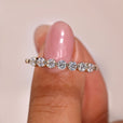 Round diamond wedding band featuring an elegant shared prong setting.