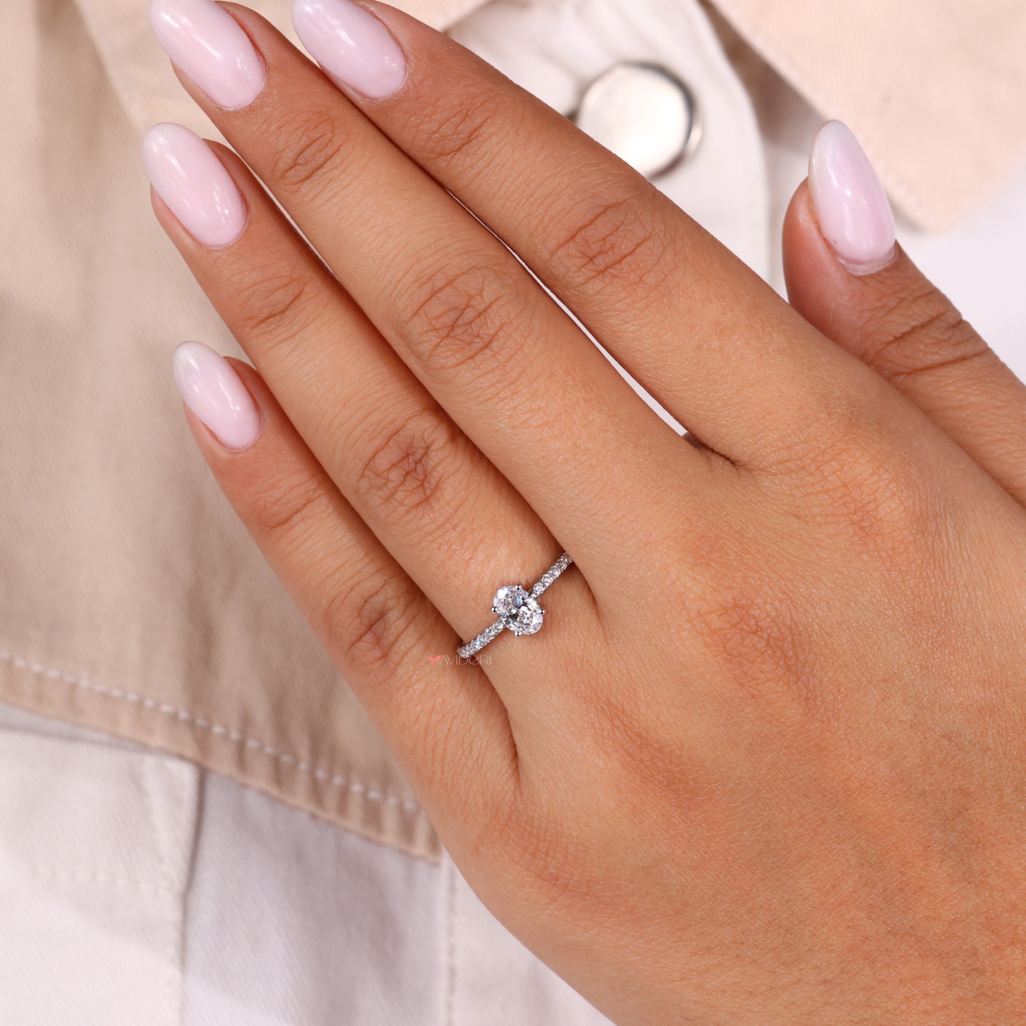 Pave round diamond ring with an oval shaped engagement ring for brilliance.