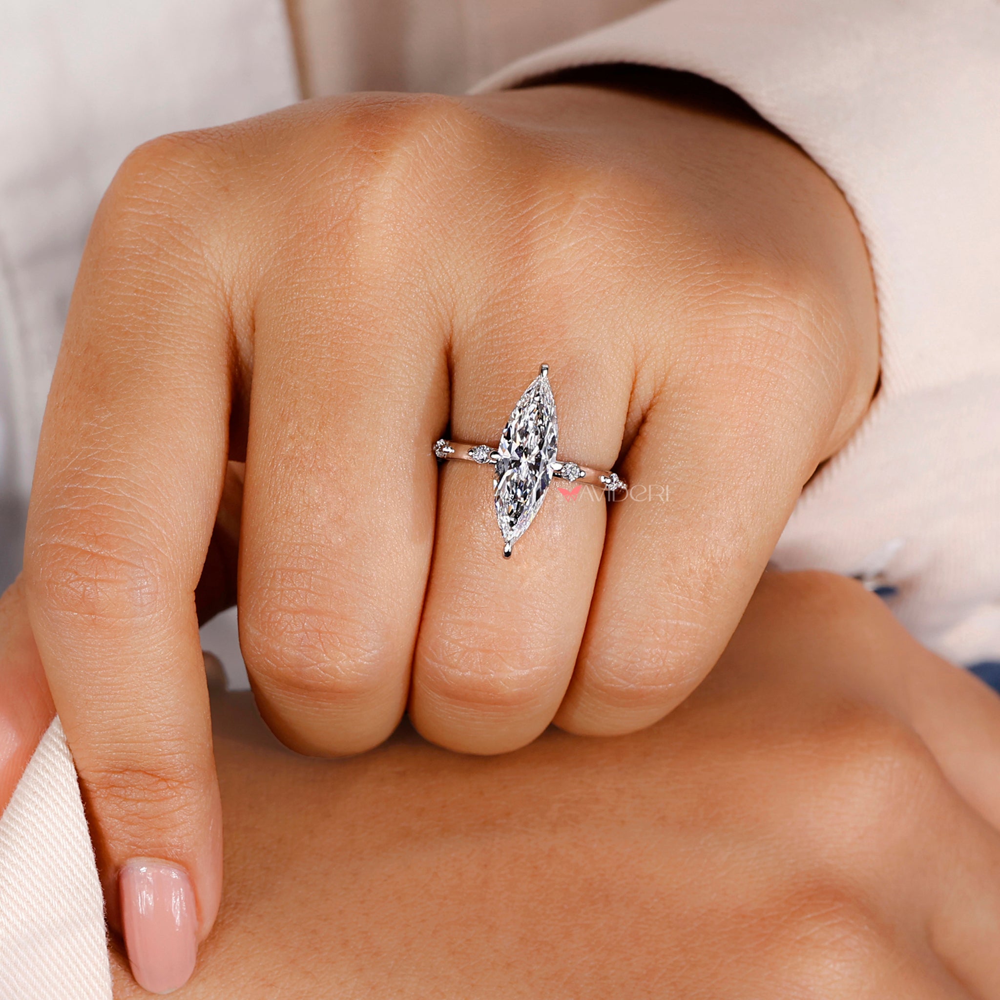 Marquise diamond ring with a prong setting ring.