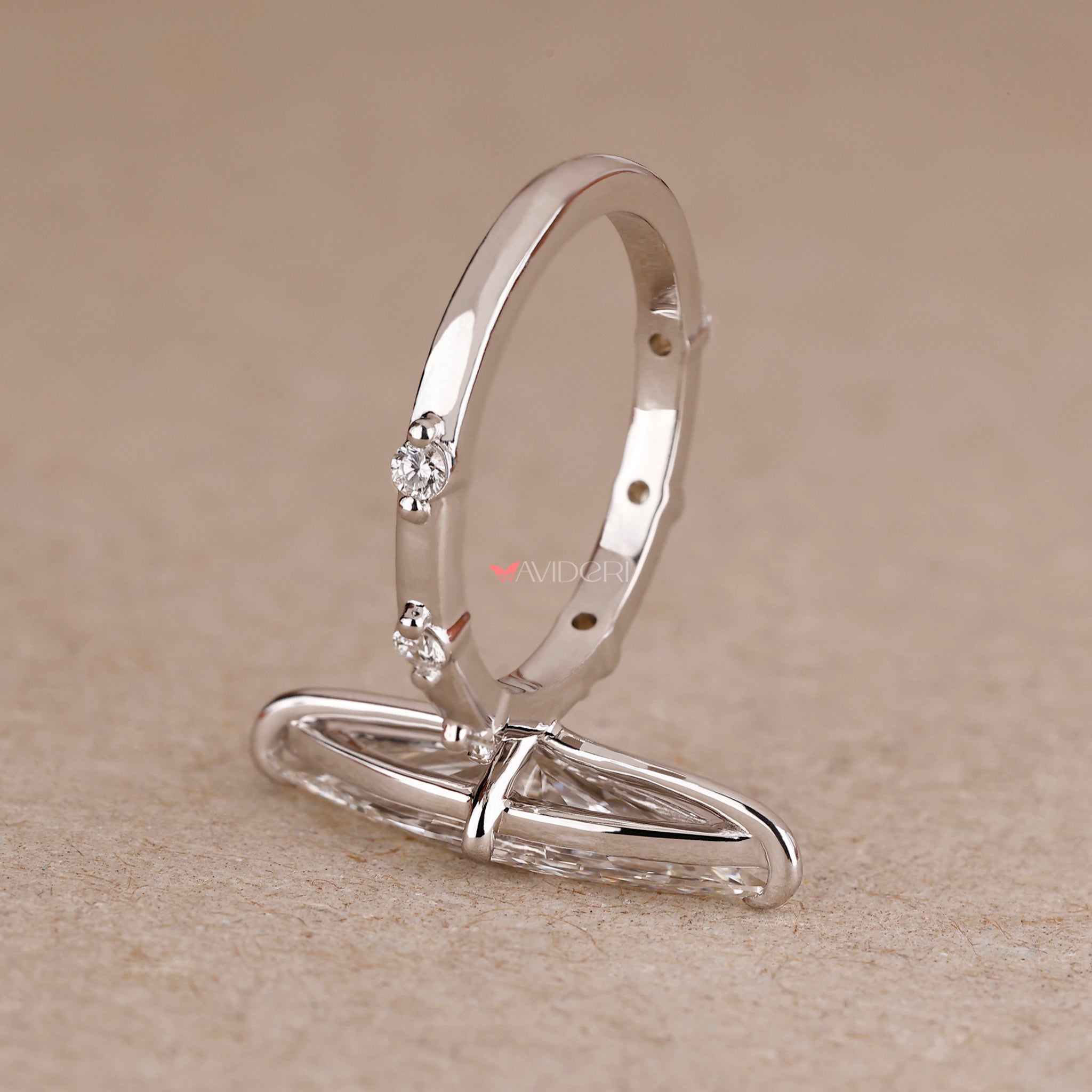 Marquise cut engagement ring with a distance pave ring.