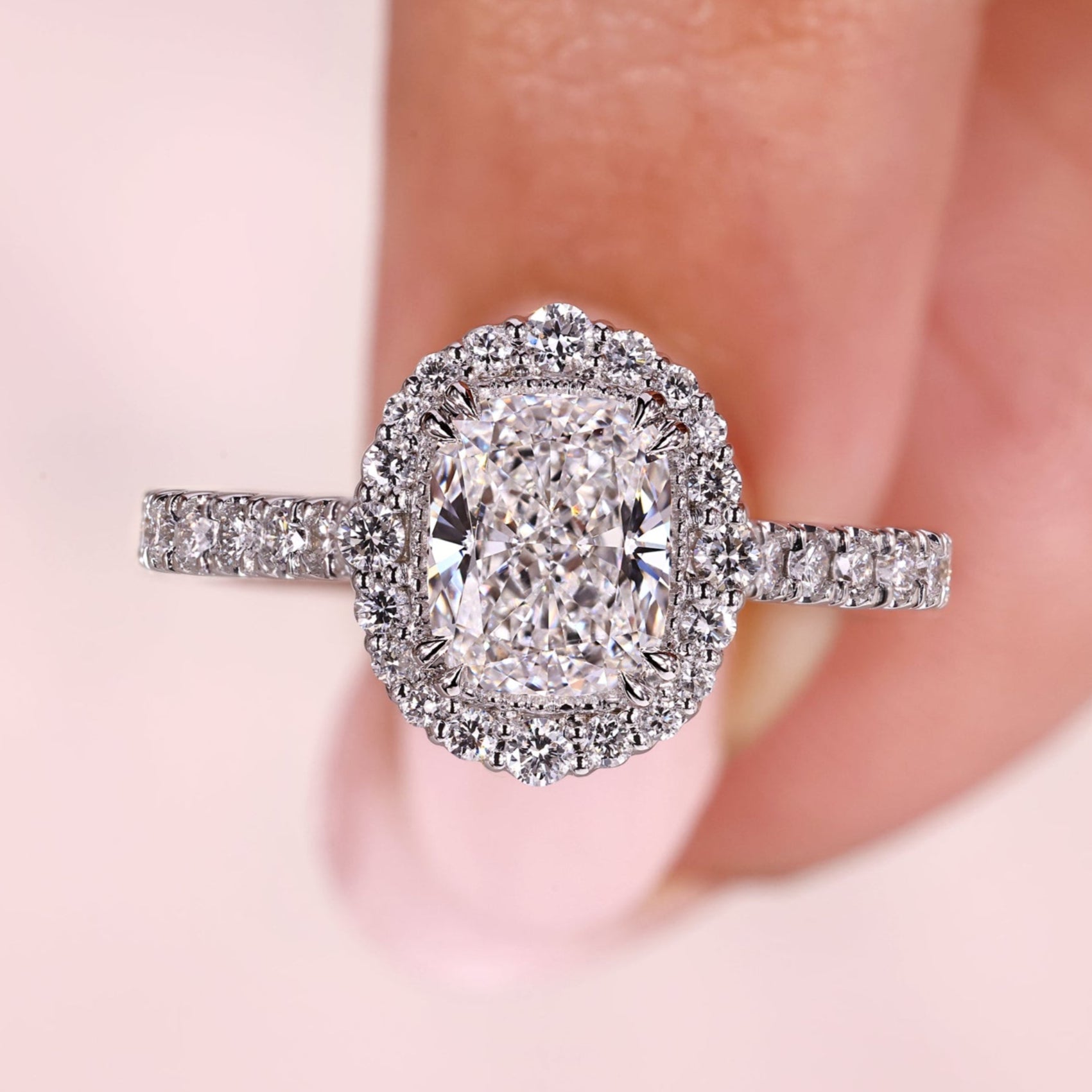Cushion diamond engagement ring with double claw prong.