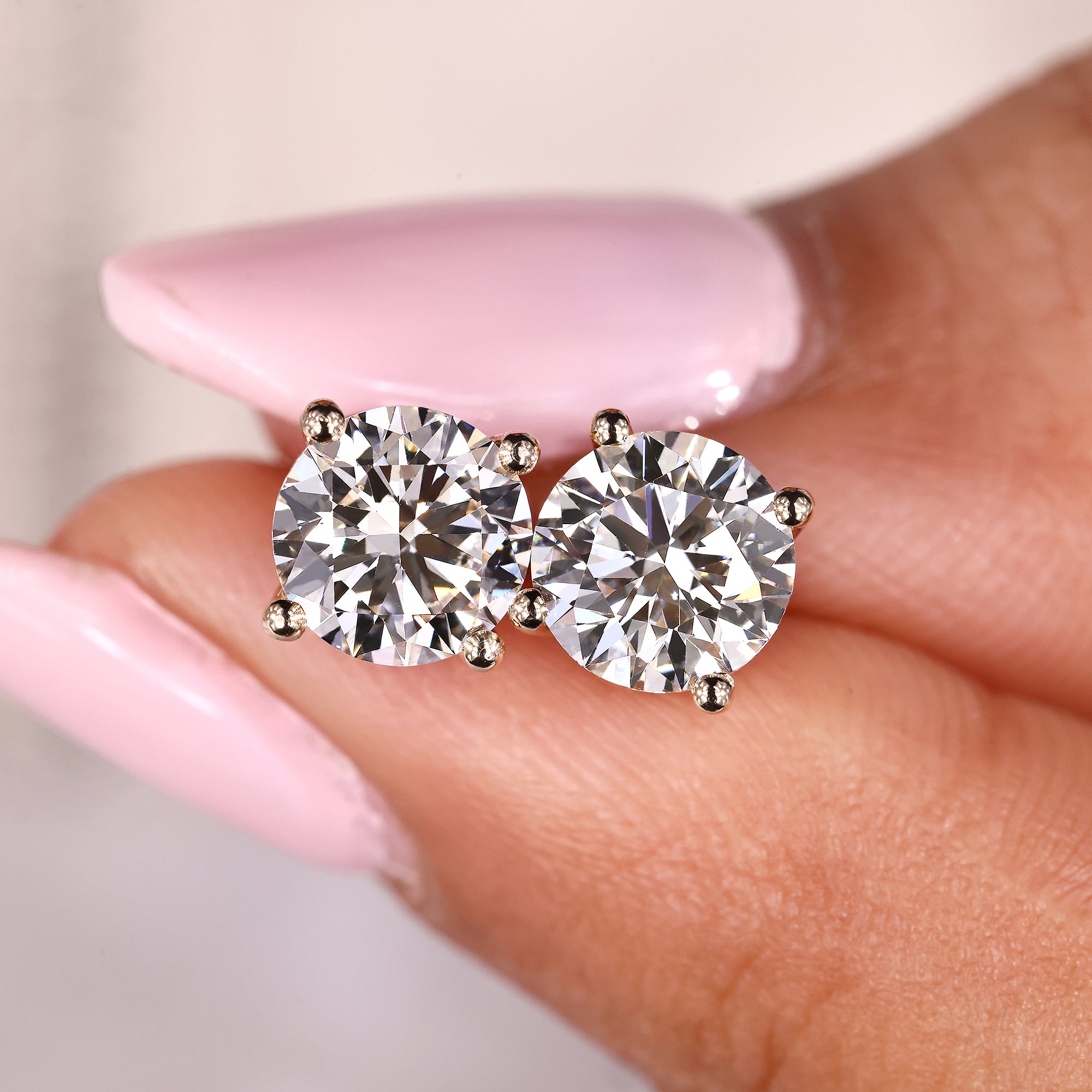 Solitaire diamond earrings with 6mm lab diamond.